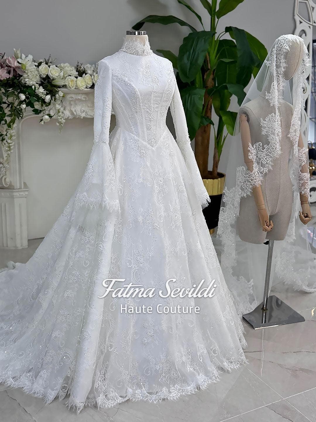 Veiled hijab wedding dress with corset bodice, bell sleeves, and beaded lace in an elegant A-line silhouette. Premium lace veil included for a complete modest bridal set.