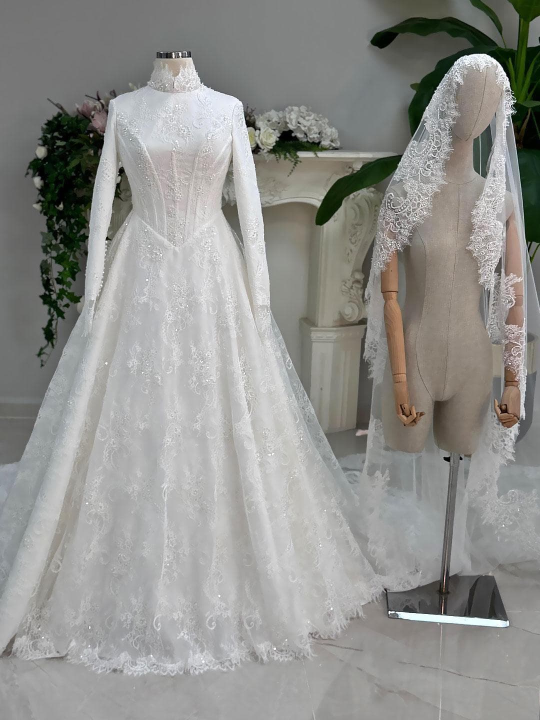 Luxury veiled hijab wedding dress with high neck, long sleeves, and beaded lace over a full A-line ball skirt. Premium lace veil included for a complete modest bridal set.