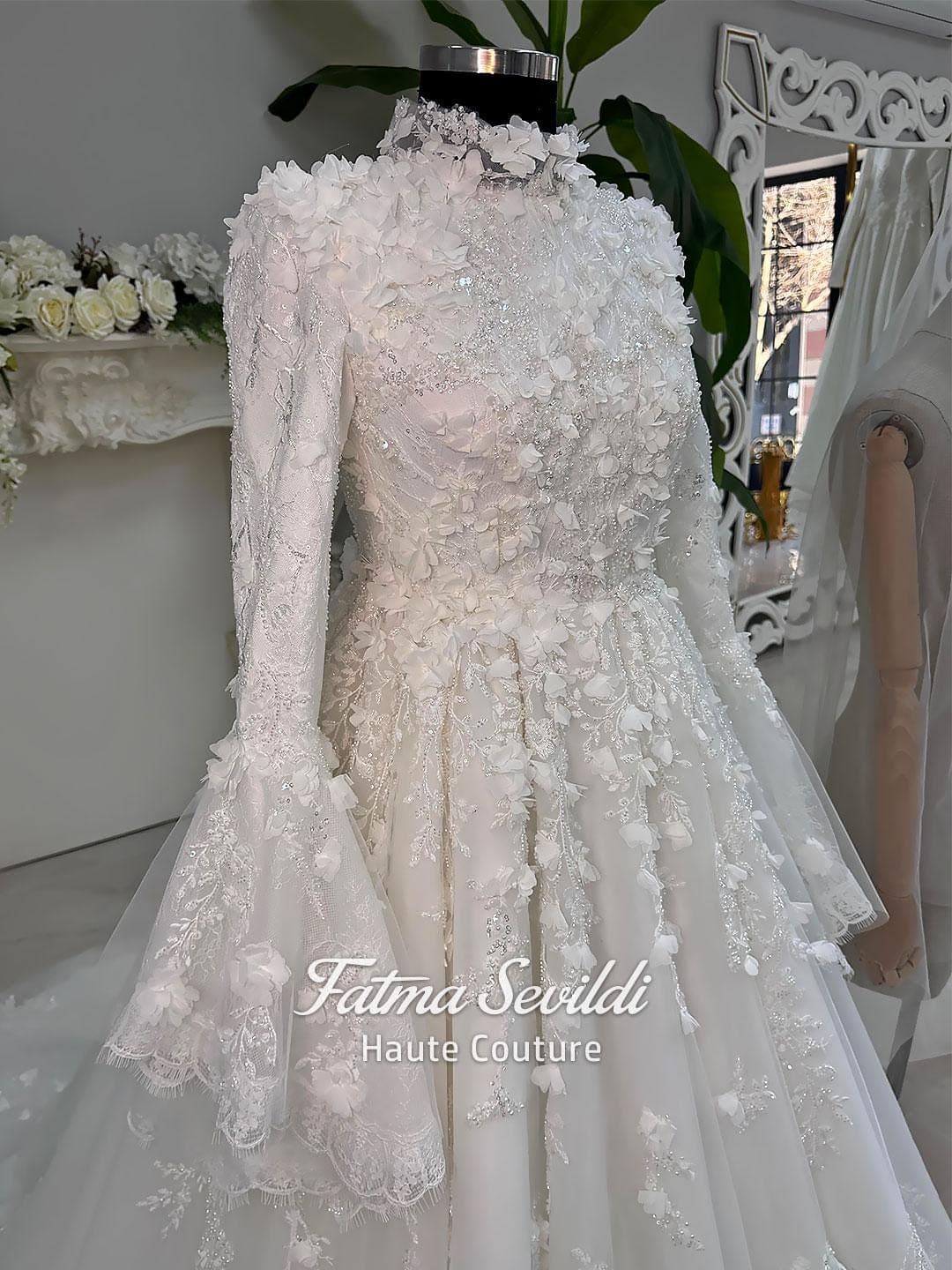 Veiled hijab wedding dress in a modest A-line silhouette with high neck, long sleeves and floral appliqué, custom made for luxury Muslim bridal coverage. Includes a matching lace veil for a complete bridal set.