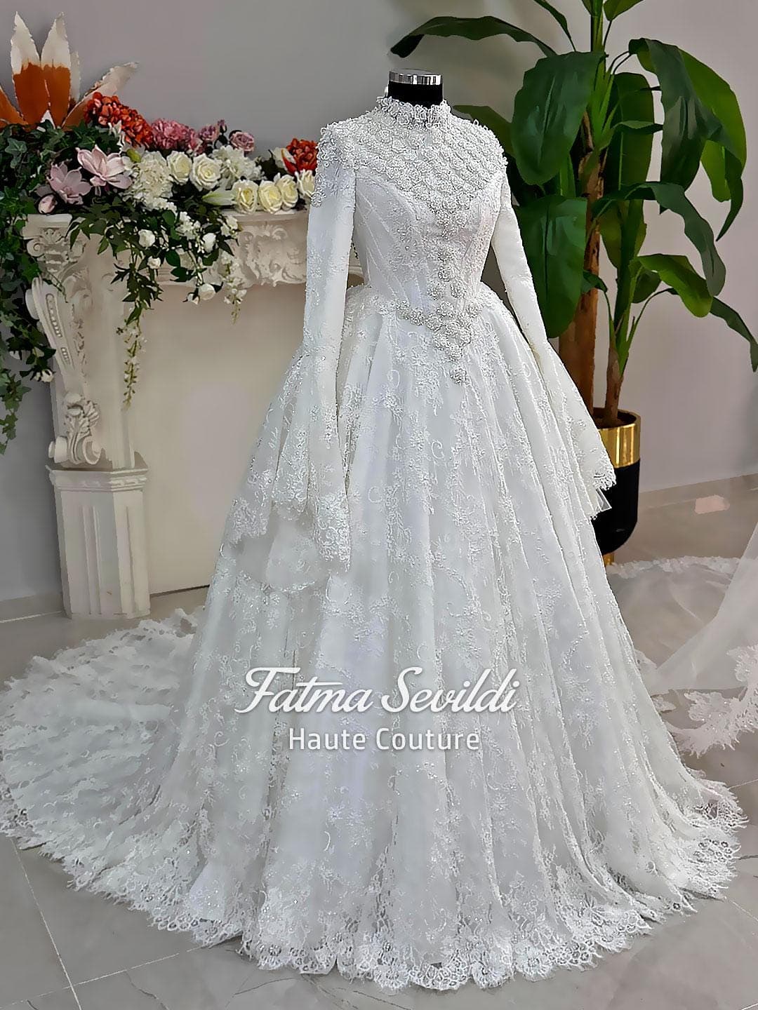 Luxury hijab wedding dress with long sleeves and high neckline, featuring beaded lace over a full ballgown silhouette and matching veiled bridal set. Couture modest bridal gown handmade in Türkiye.