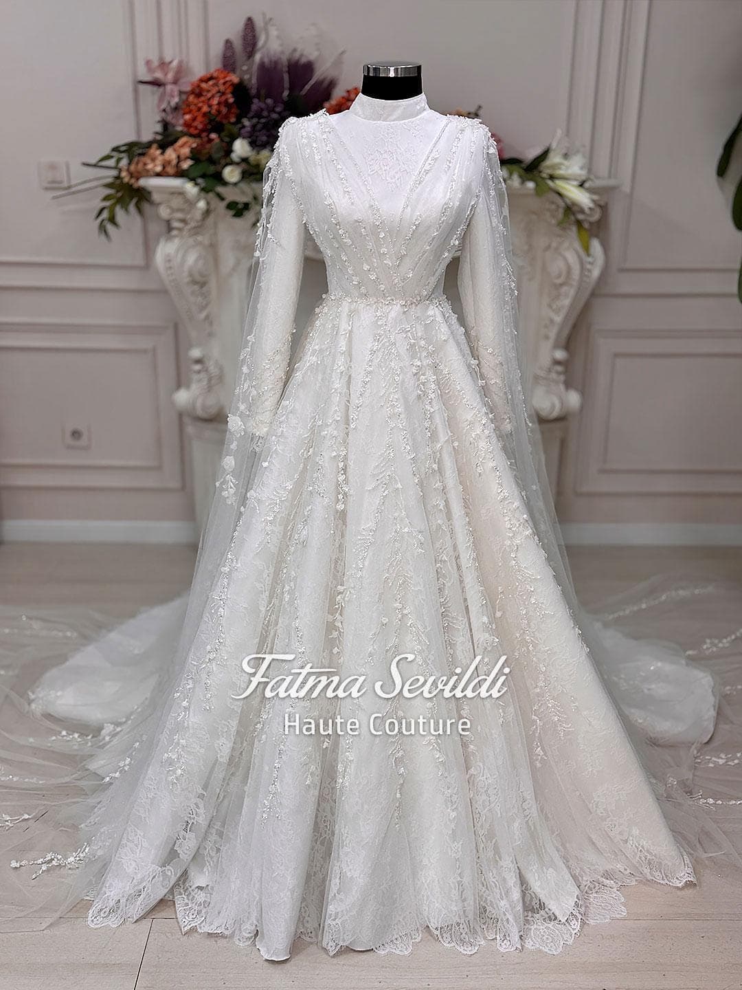 Veiled hijab wedding dress with floral lace, long sleeves and a modest A-line silhouette, handcrafted for a luxury muslim bridal look. Includes a matching premium lace veil for an elegant full-coverage finish.