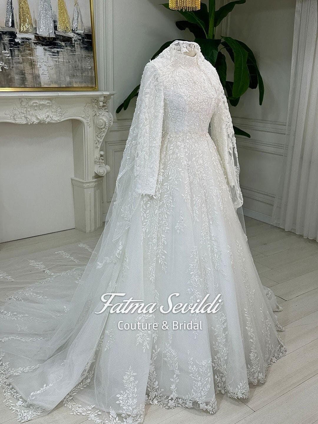 Veiled hijab wedding dress in a luxury 3D lace ballgown silhouette with high neck and long sleeves, made to measure for modest bridal coverage. Includes a matching premium lace veil for a complete Muslim bridal set.