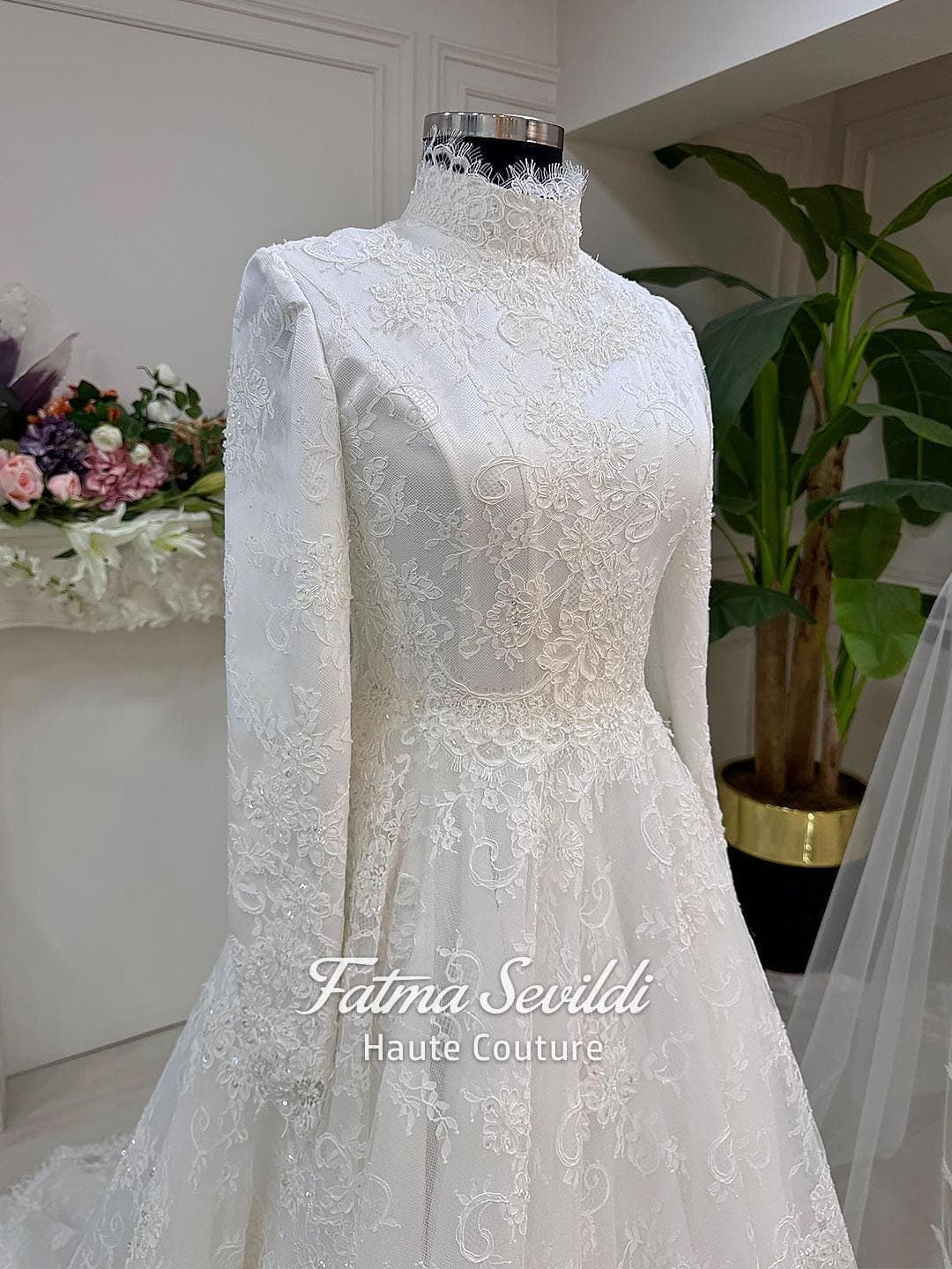 Veiled hijab wedding dress with high neck, long sleeves, and shimmering beaded lace over satin with a full skirt. Includes petticoat, headscarf, and a lace edge veil for a complete modest bridal set.