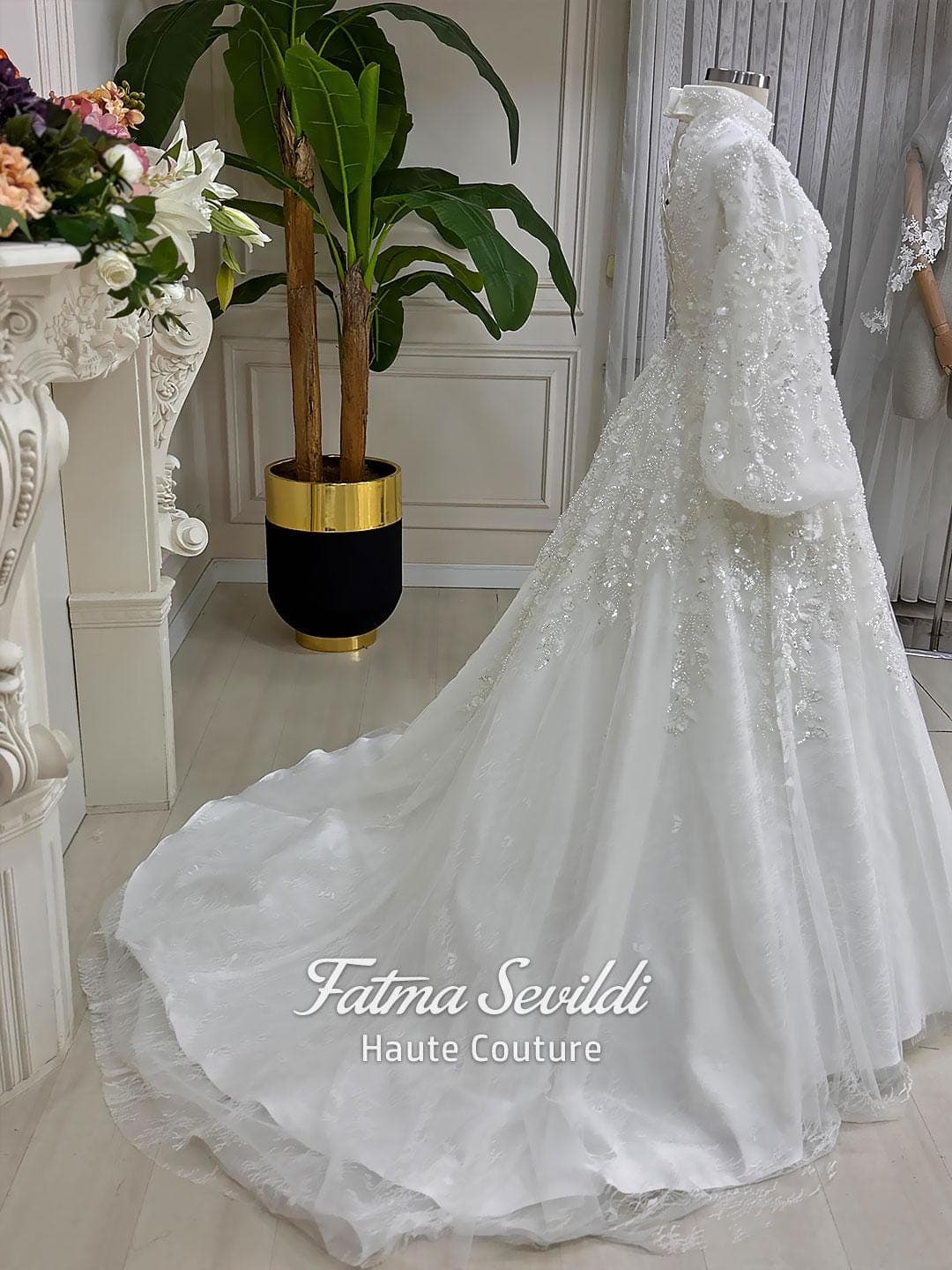 Luxury hijab wedding dress with high neck, long sleeves, beaded embroidery, full skirt, and matching premium lace veil. Elegant modest bridal gown designed for Muslim brides seeking a couture wedding look.