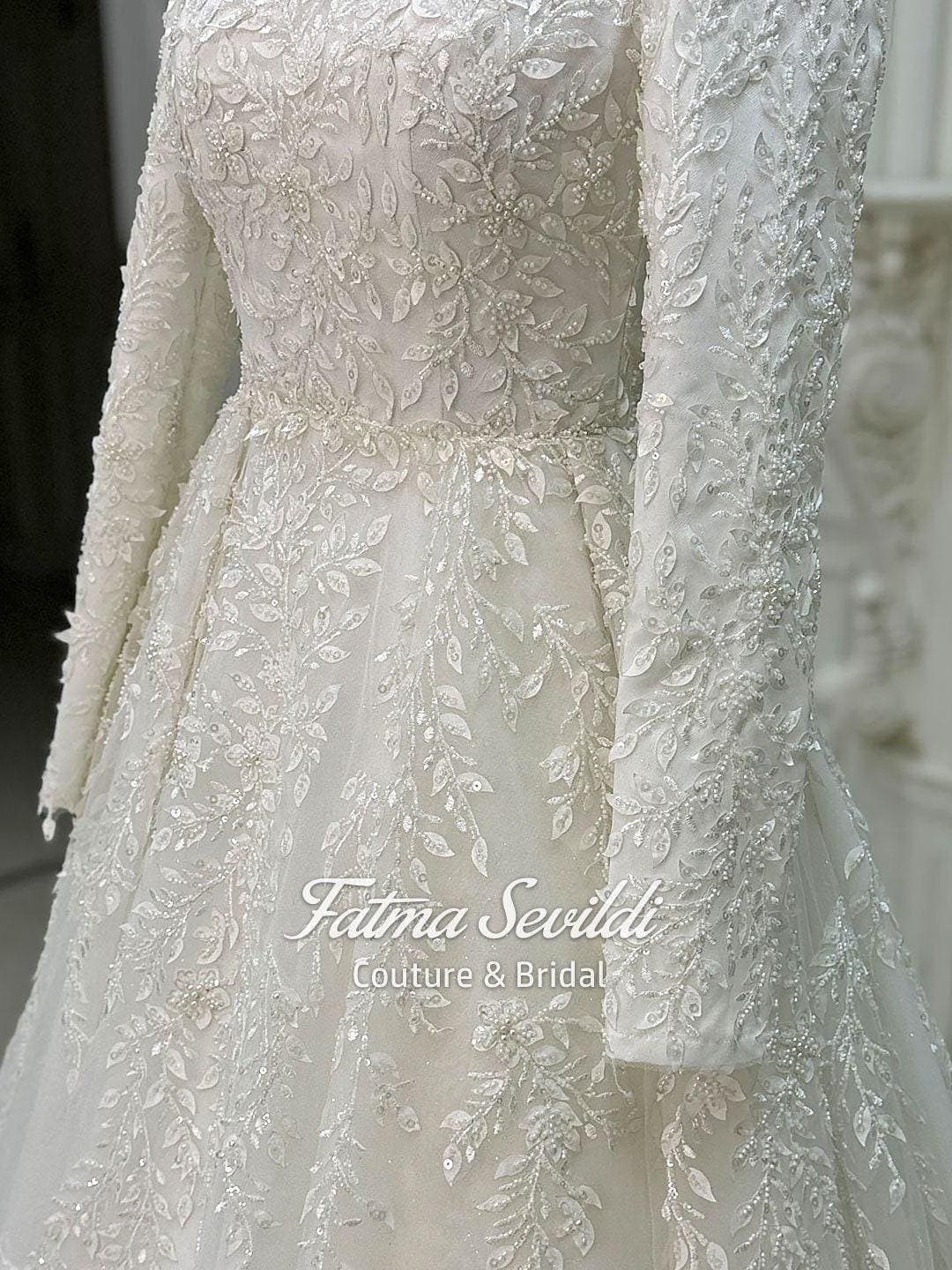 Veiled hijab wedding dress in a luxury 3D lace ballgown silhouette with high neck and long sleeves, made to measure for modest bridal coverage. Includes a matching premium lace veil for a complete Muslim bridal set.