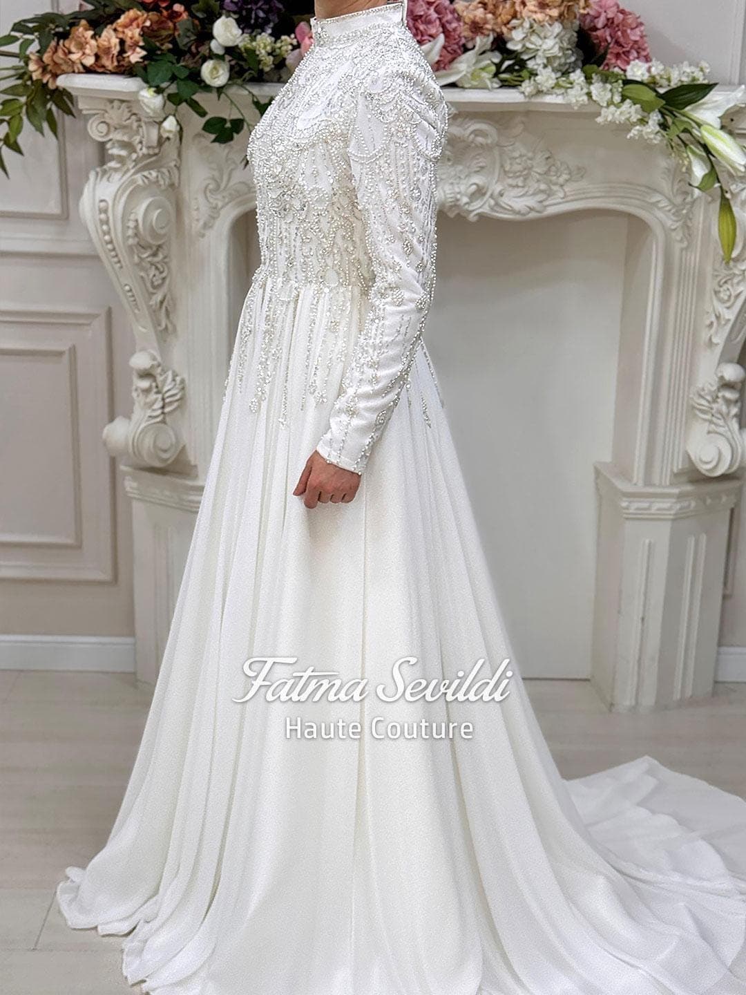 Luxury hijab wedding dress with beaded lace, high neck and long sleeves in a modest A-line silhouette, custom made for elegant Muslim bridal coverage. Sparkling couture beadwork on satin and tulle for a refined finish.