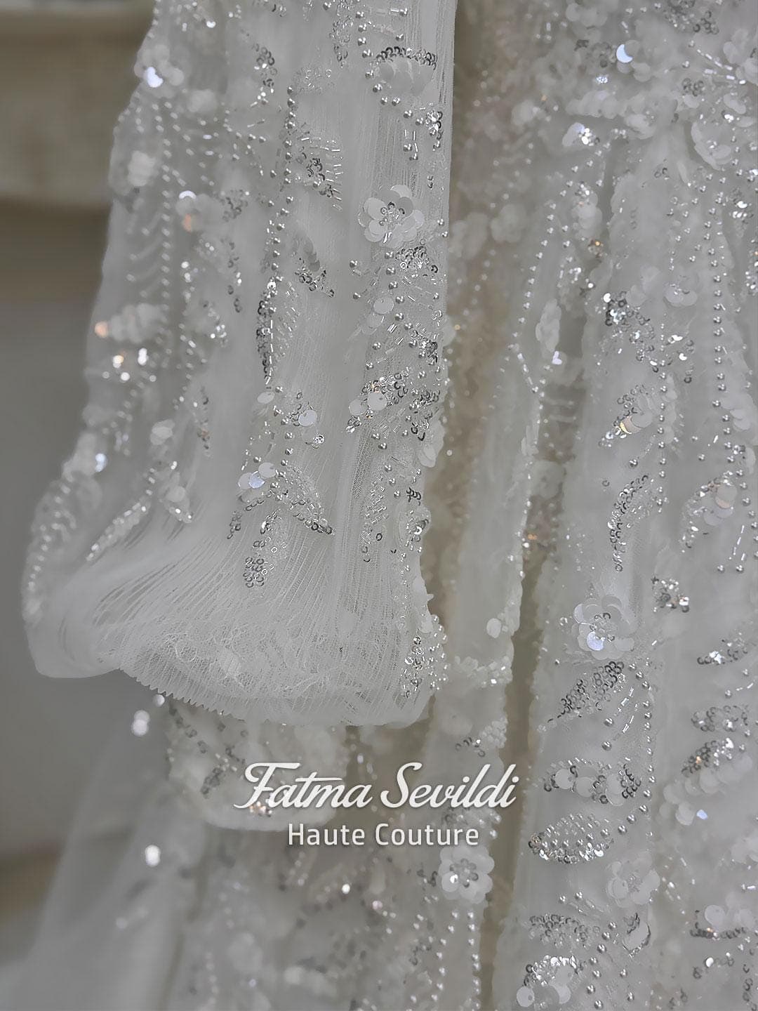 Luxury hijab wedding dress with high neck, long sleeves, beaded embroidery, full skirt, and matching premium lace veil. Elegant modest bridal gown designed for Muslim brides seeking a couture wedding look.