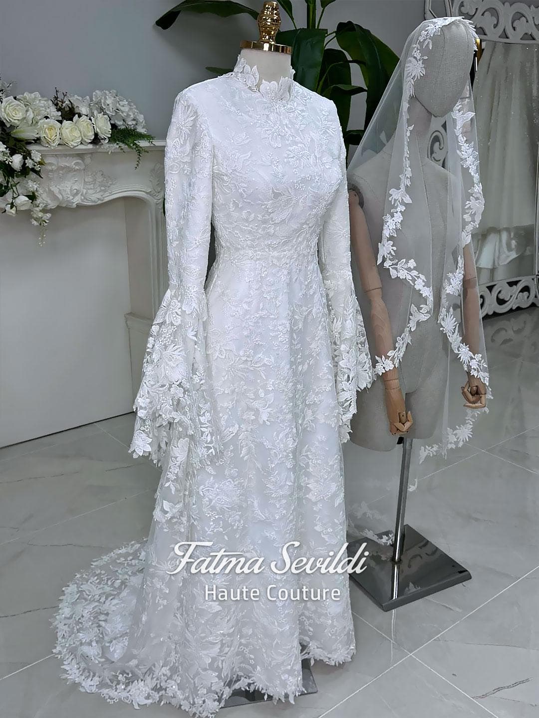 Veiled hijab wedding dress with high neck, long sleeves, and beaded floral lace in an elegant A-line couture silhouette.