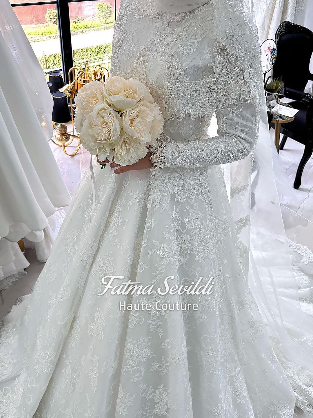 Veiled hijab wedding dress with lace capelet, high neck, long sleeves, and couture beaded lace in a regal ball gown silhouette. Includes premium lace veil, headscarf, and petticoat.