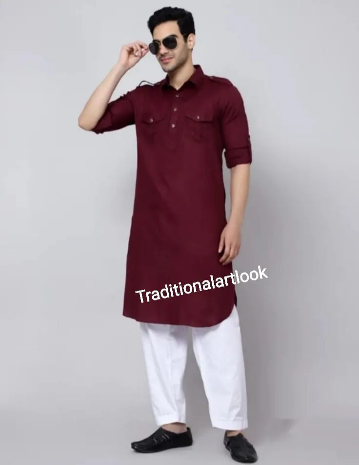 May include: A maroon long-sleeved kurta with a button-up collar and two flap pockets. The kurta is worn with white pants and black shoes. The text "Traditionalartlook" is visible on the bottom of the kurta.