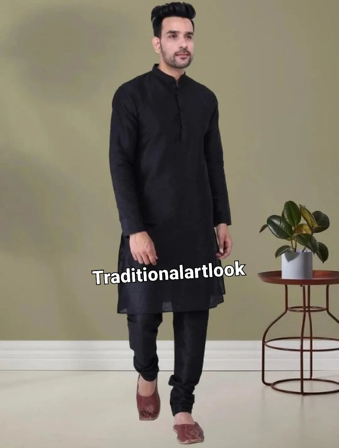 May include: Black kurta pajama set. The long-sleeved kurta has a mandarin collar and button-down front. The matching pajama pants are straight-legged. The outfit is worn with brown leather slip-on shoes. The text "Traditionalartlook" is visible on the garment.