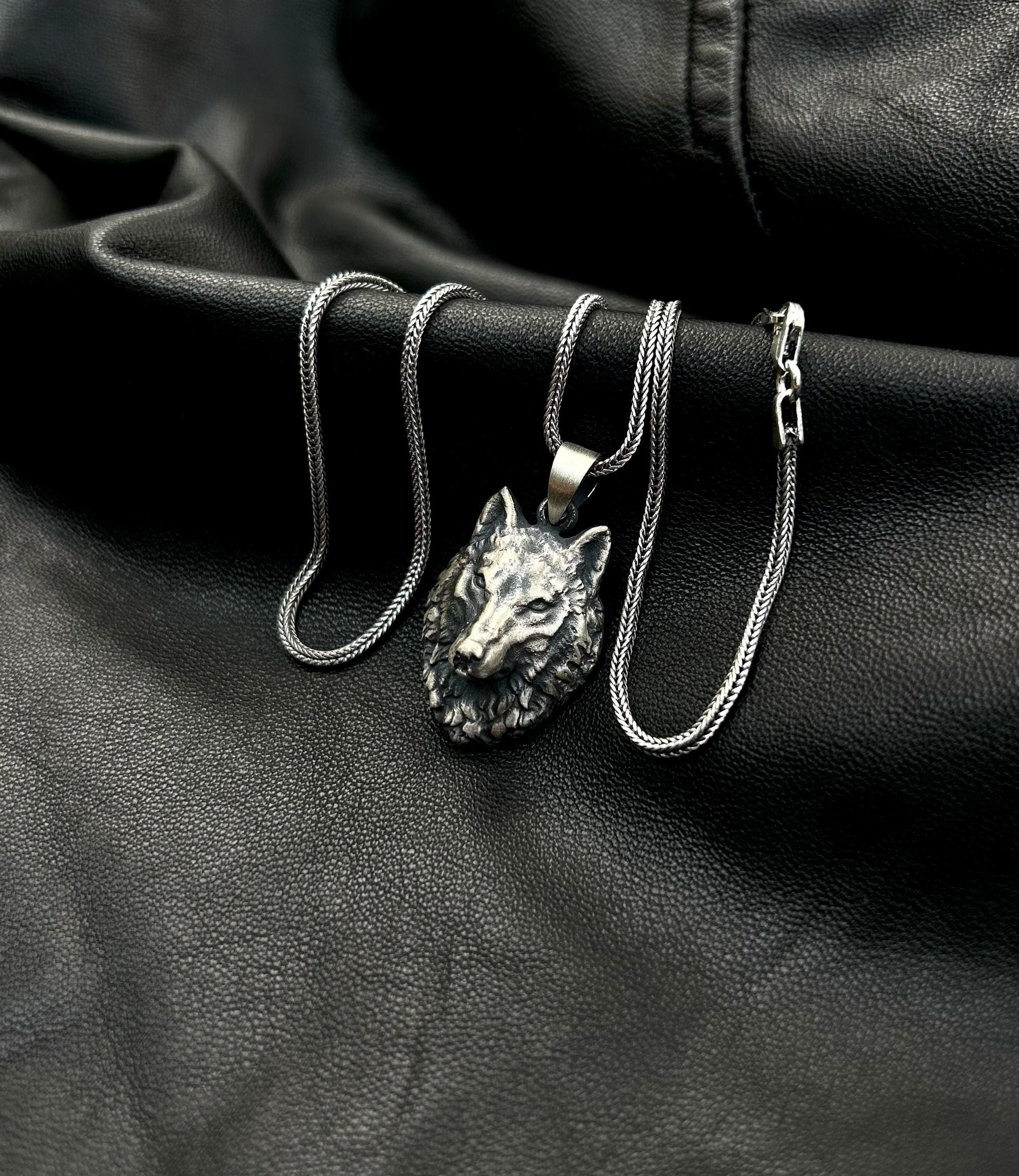 A high-quality 925 sterling silver wolf necklace for men, shown as a stylish accessory on a dark background.