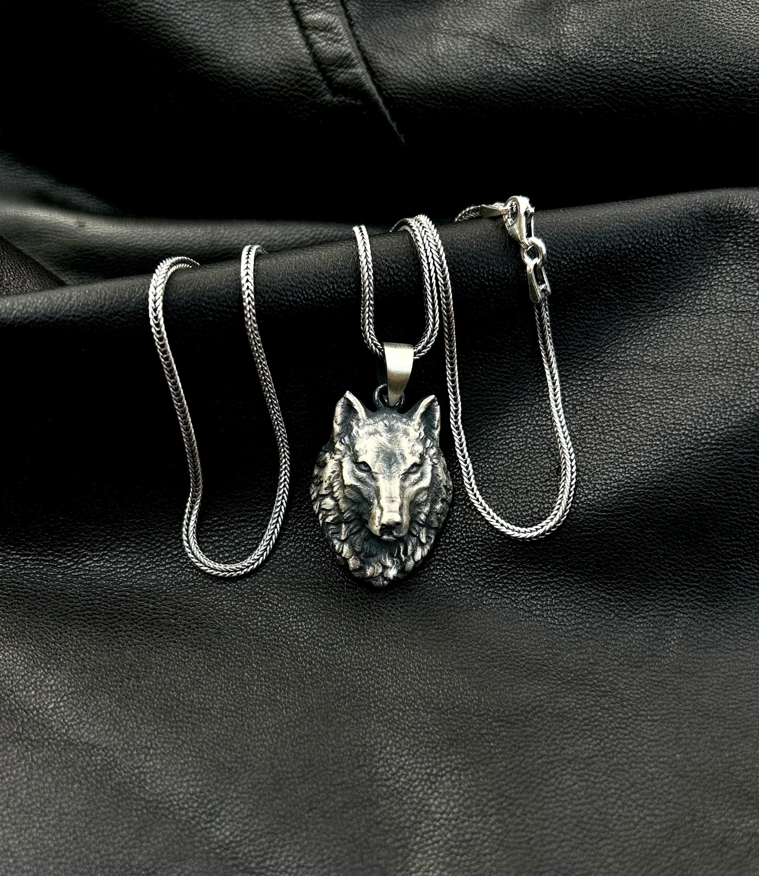 A high-quality 925 sterling silver wolf necklace for men, shown as a stylish accessory on a dark background.