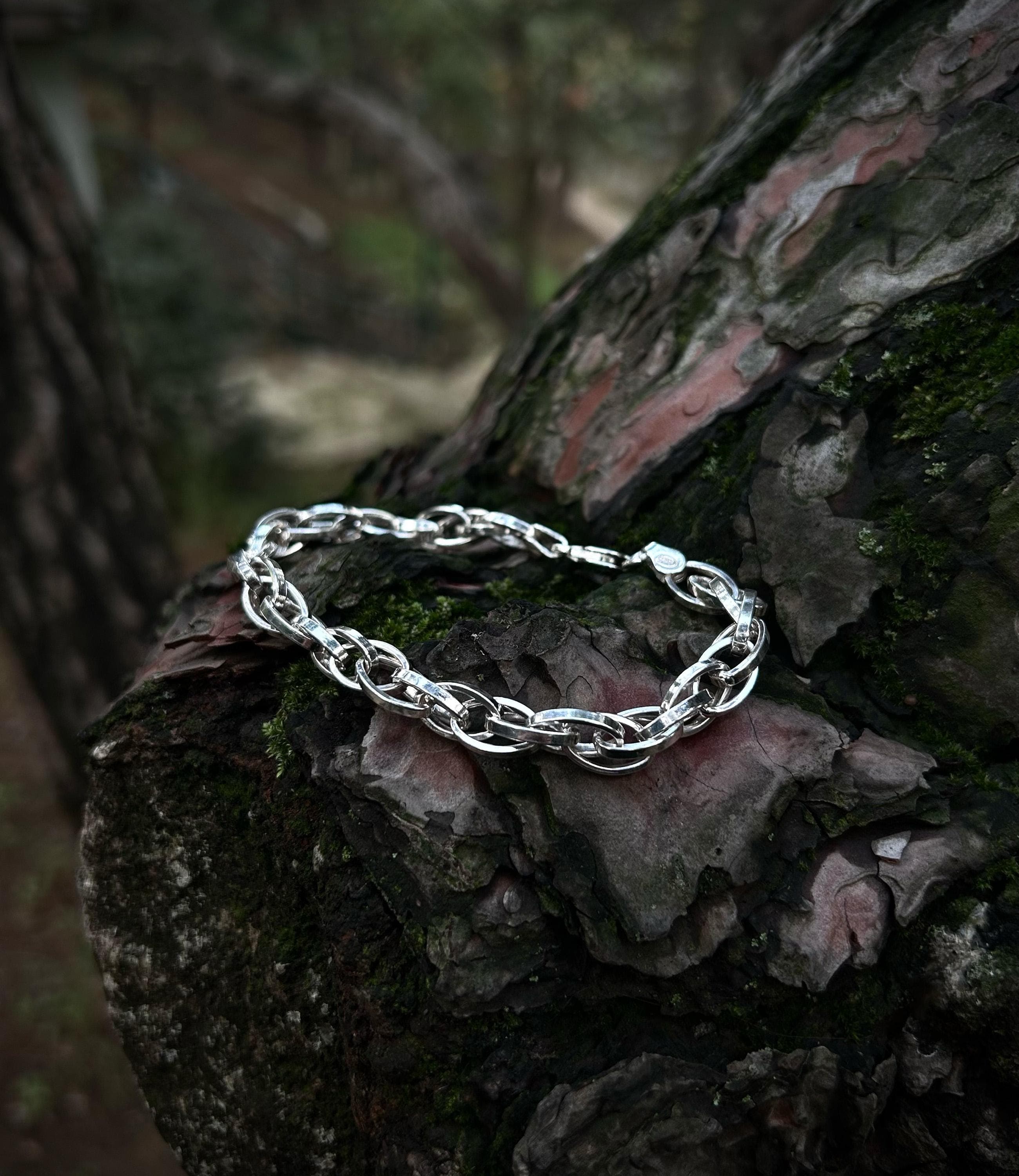 A durable, hand-soldered 925 sterling silver paperclip bracelet with interlocking oval links, shown in detail to highlight its solid construction.