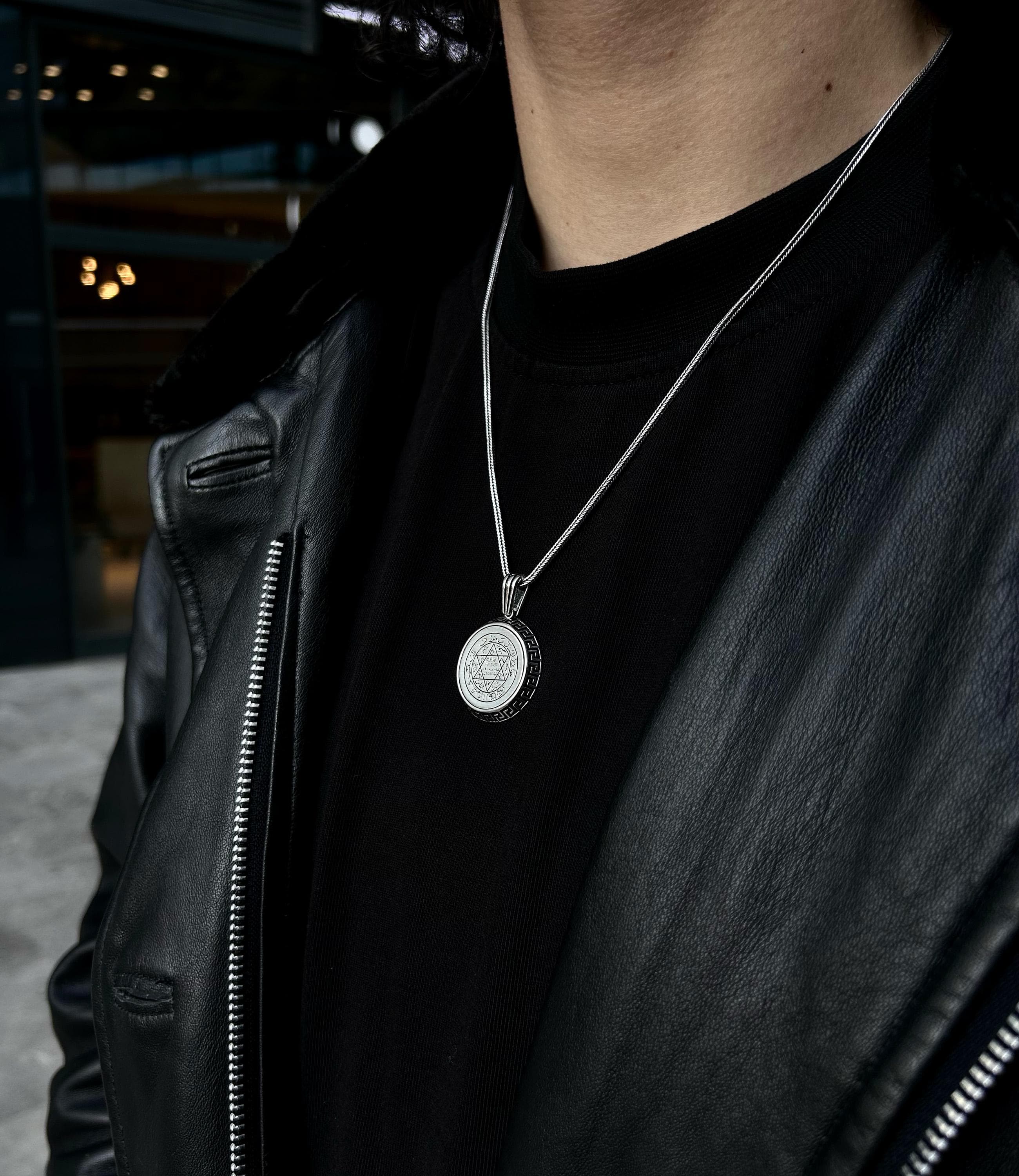 A classic 925 sterling silver Star of David pendant necklace, displayed as a meaningful religious accessory on a dark background.