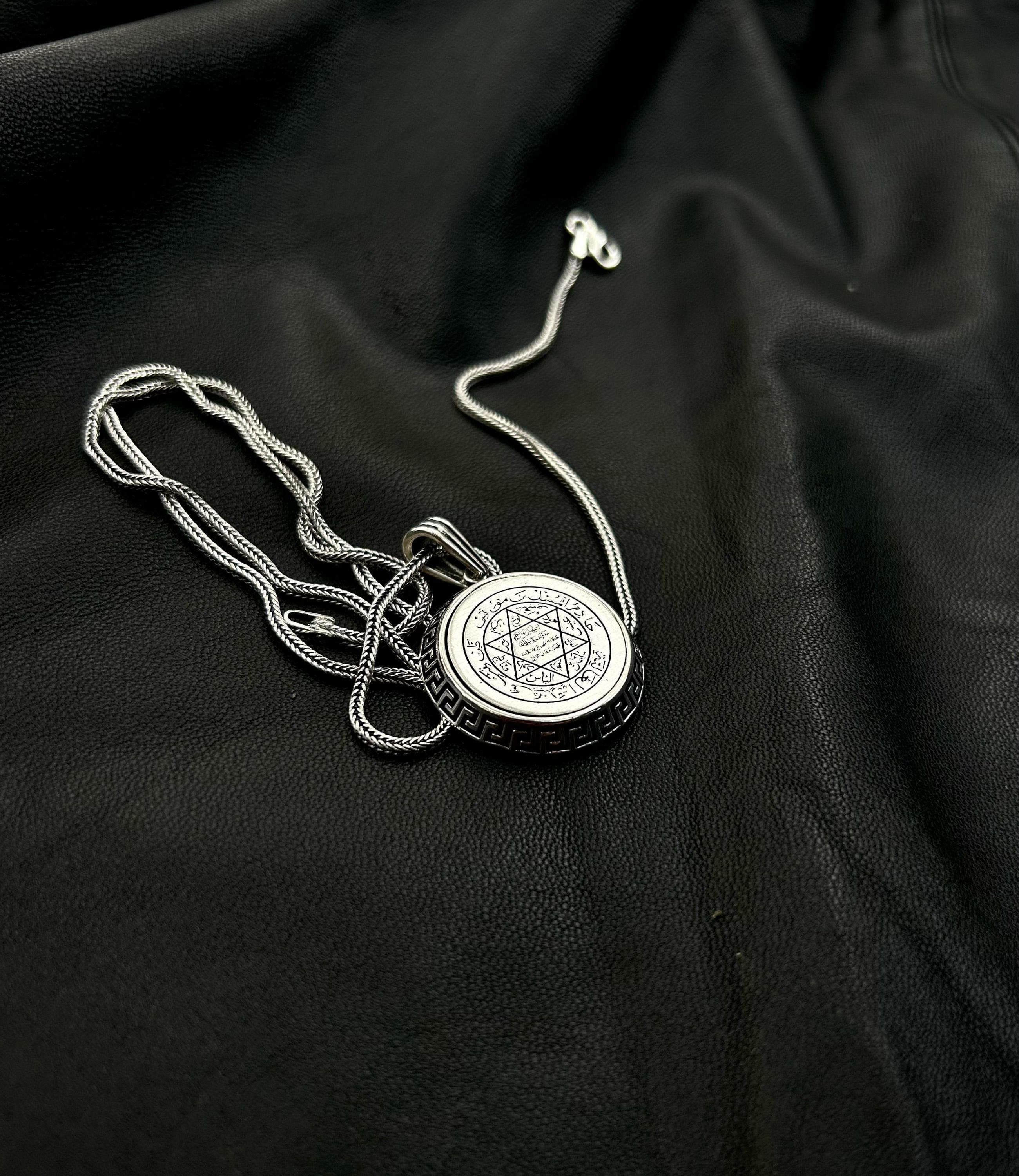 A classic 925 sterling silver Star of David pendant necklace, displayed as a meaningful religious accessory on a dark background.