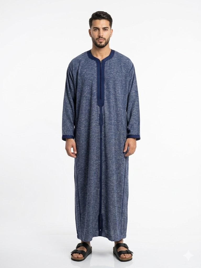Man wearing a navy blue handmade linen Moroccan kaftan with long sleeves, standing against a plain background.