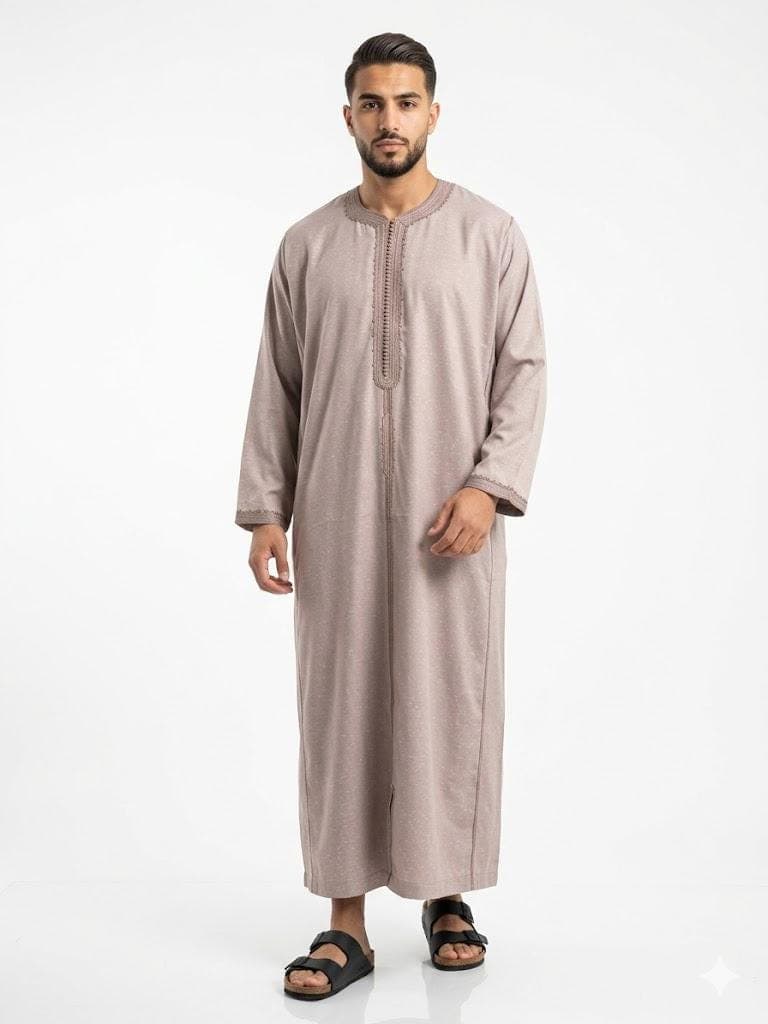 Man wearing a beige handmade linen Moroccan kaftan with long sleeves, standing against a plain background.
