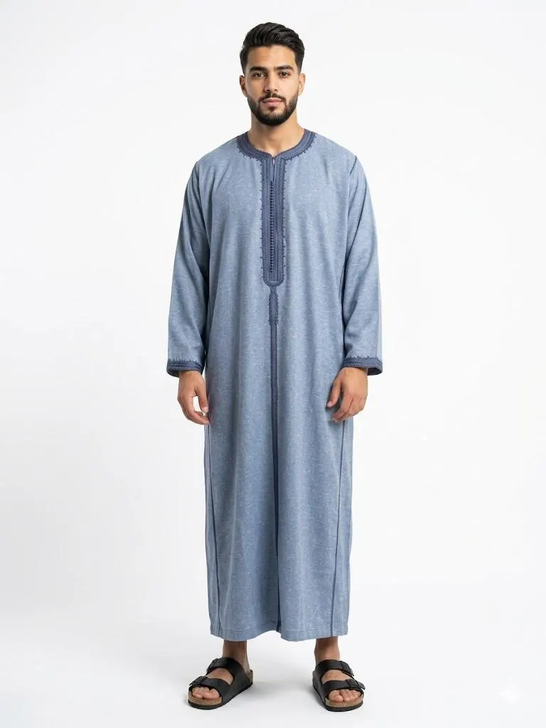 Man wearing a grey handmade linen Moroccan kaftan with long sleeves, standing against a plain background.