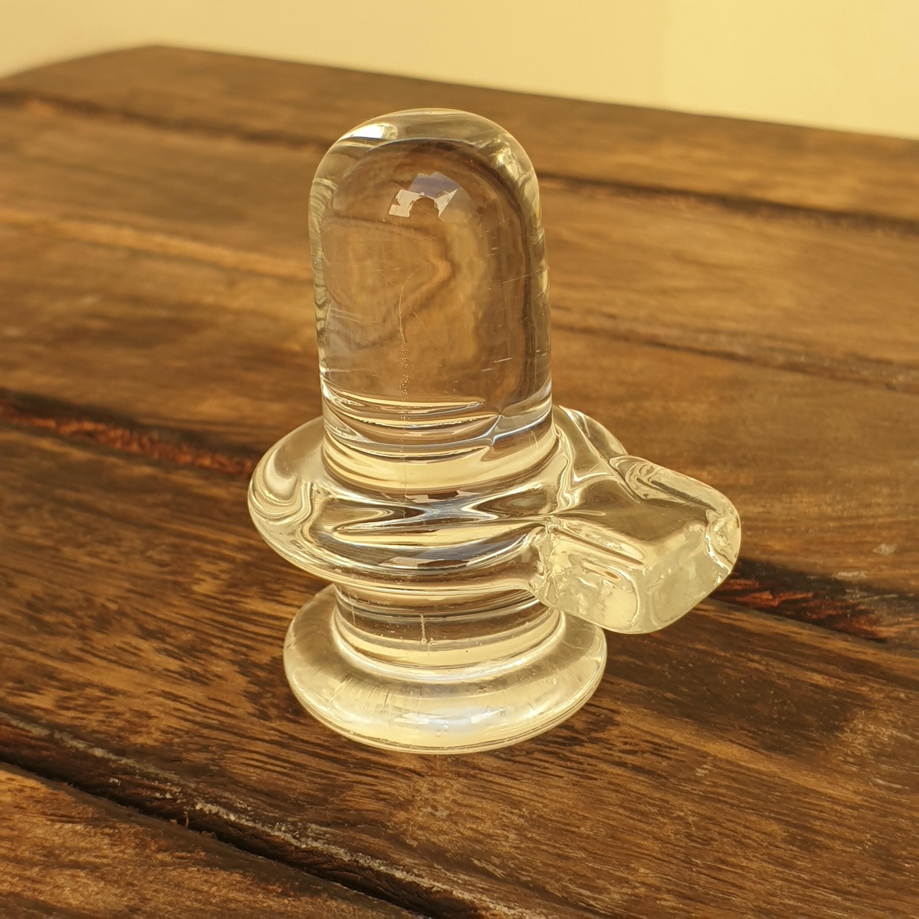 sphatik shivling,
crystal shiva lingam,
clear quartz lingam,
shiva lingam crystal,
hindu home temple,
shivling for pooja,	
 spiritual home decor,
meditation altar decor,
lord shiva idol,
 maha shivratri gift,
vastu healing crystal,
yoga room decor,
hindu religious gift