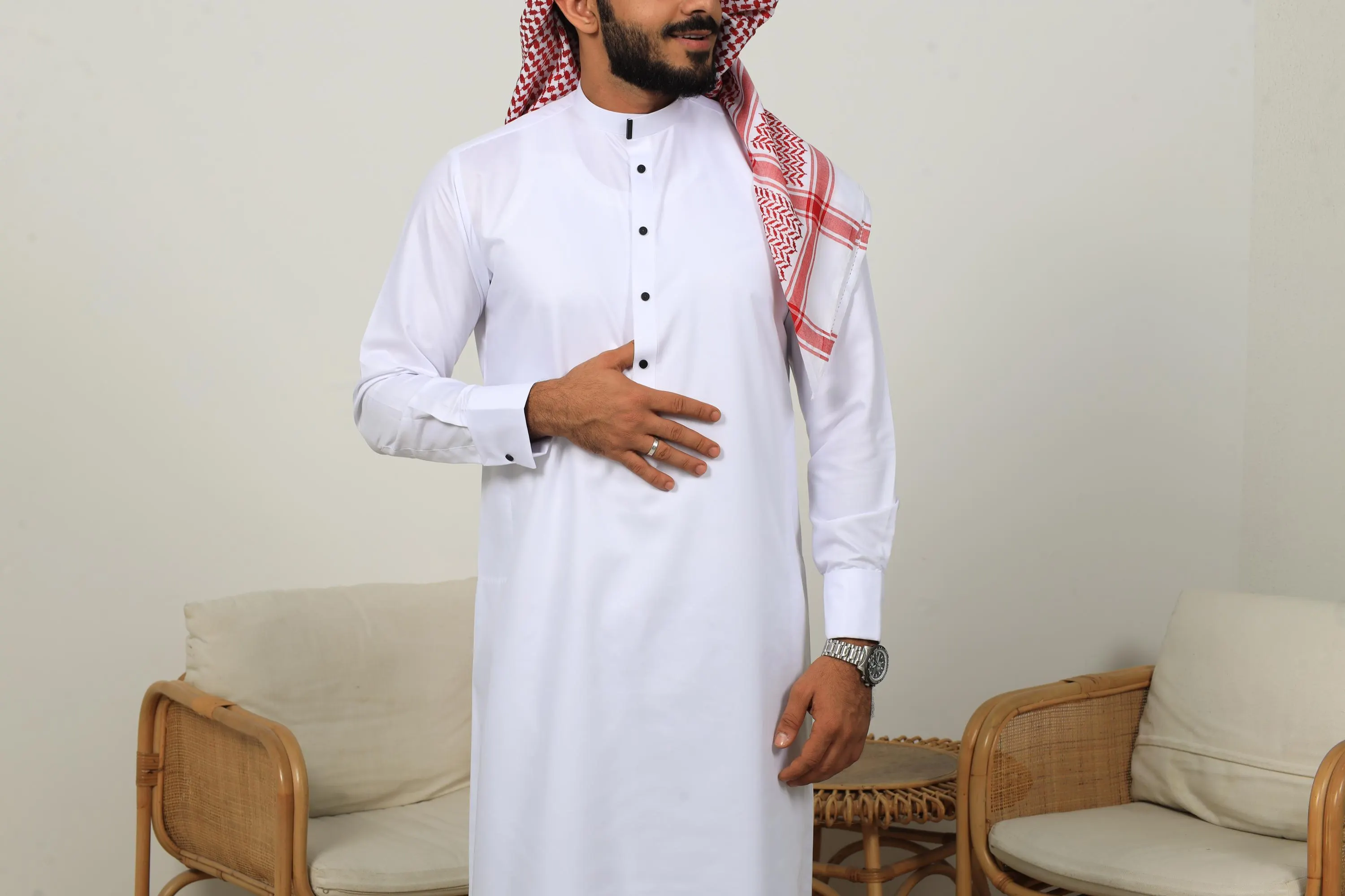 White Collar thobe with black buttons styled with a red and white keffiyeh scarf