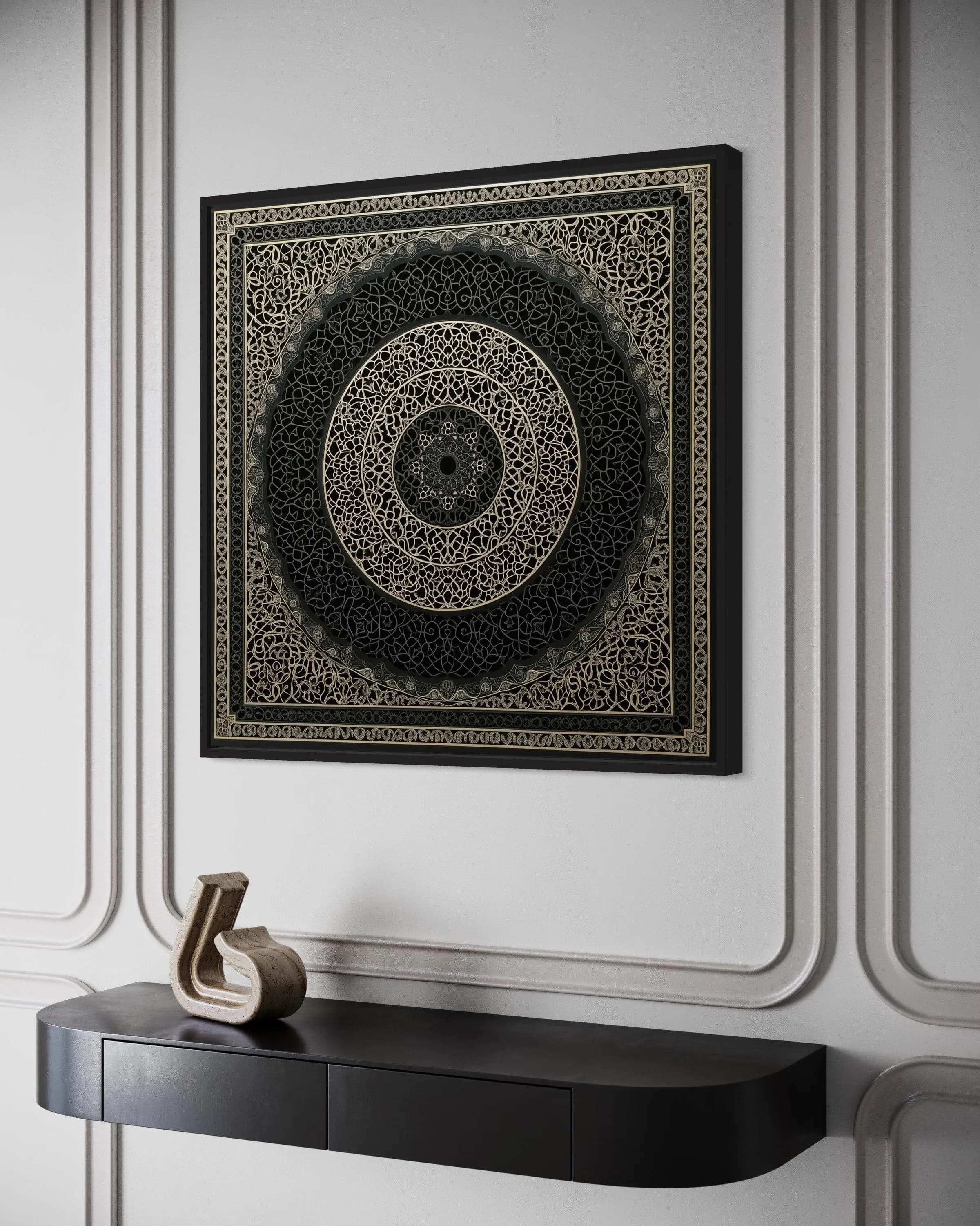 a black and gold decorative wall hanging with an intricate circular design, mounted on a white wall above a black shelf with a gold sculpture on it.