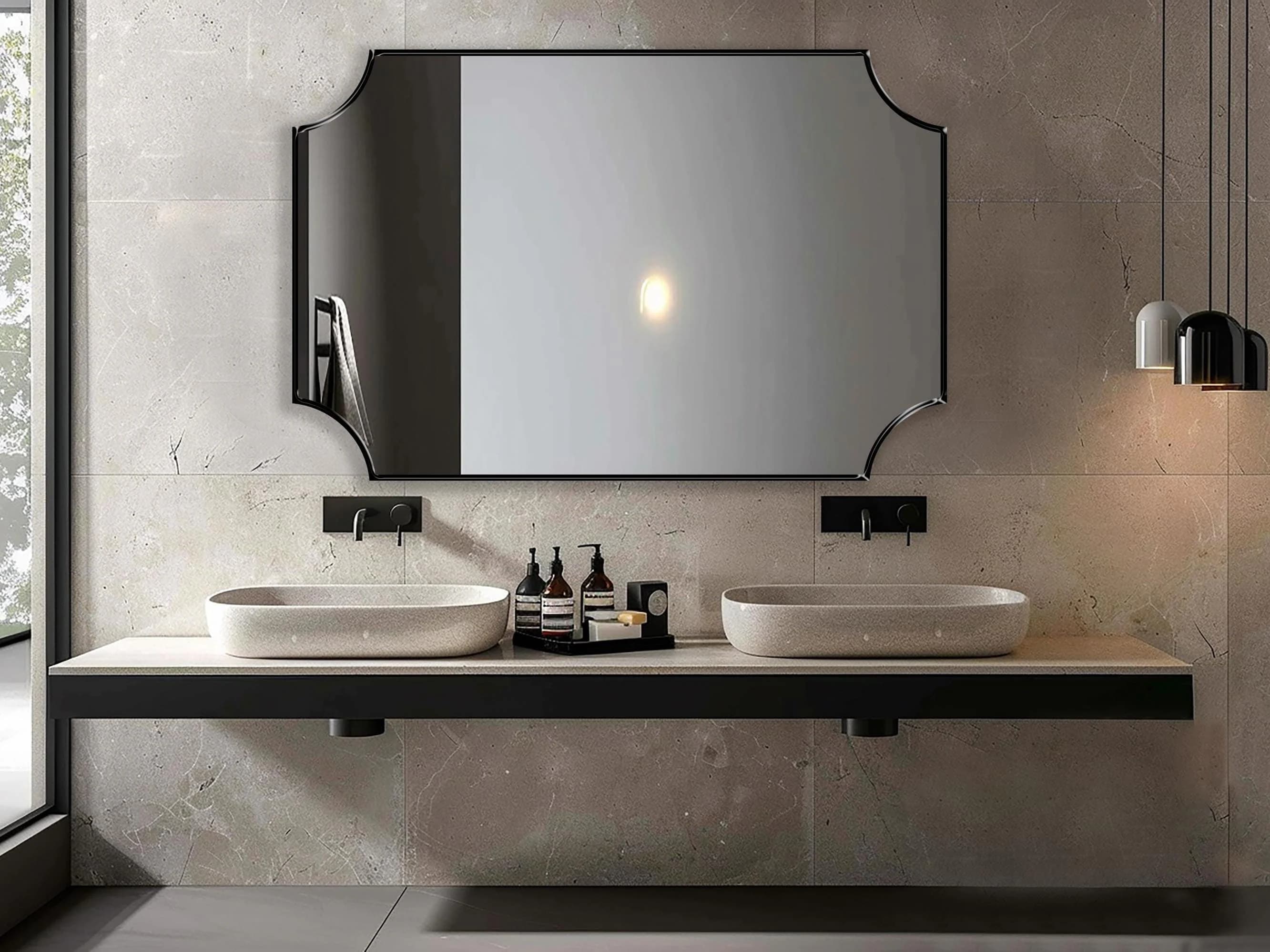 Scalloped Rectangle Mirror with black frame hung on the wall of a bathroom over double vanity.