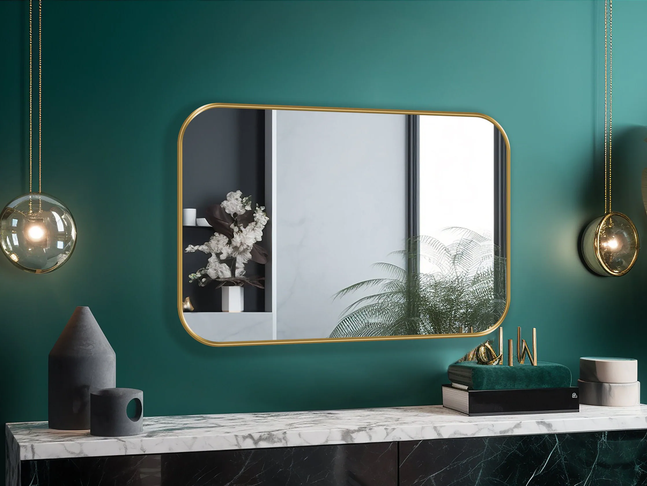 Rectangle mirror with gold frame hung on the wall of an entryway.