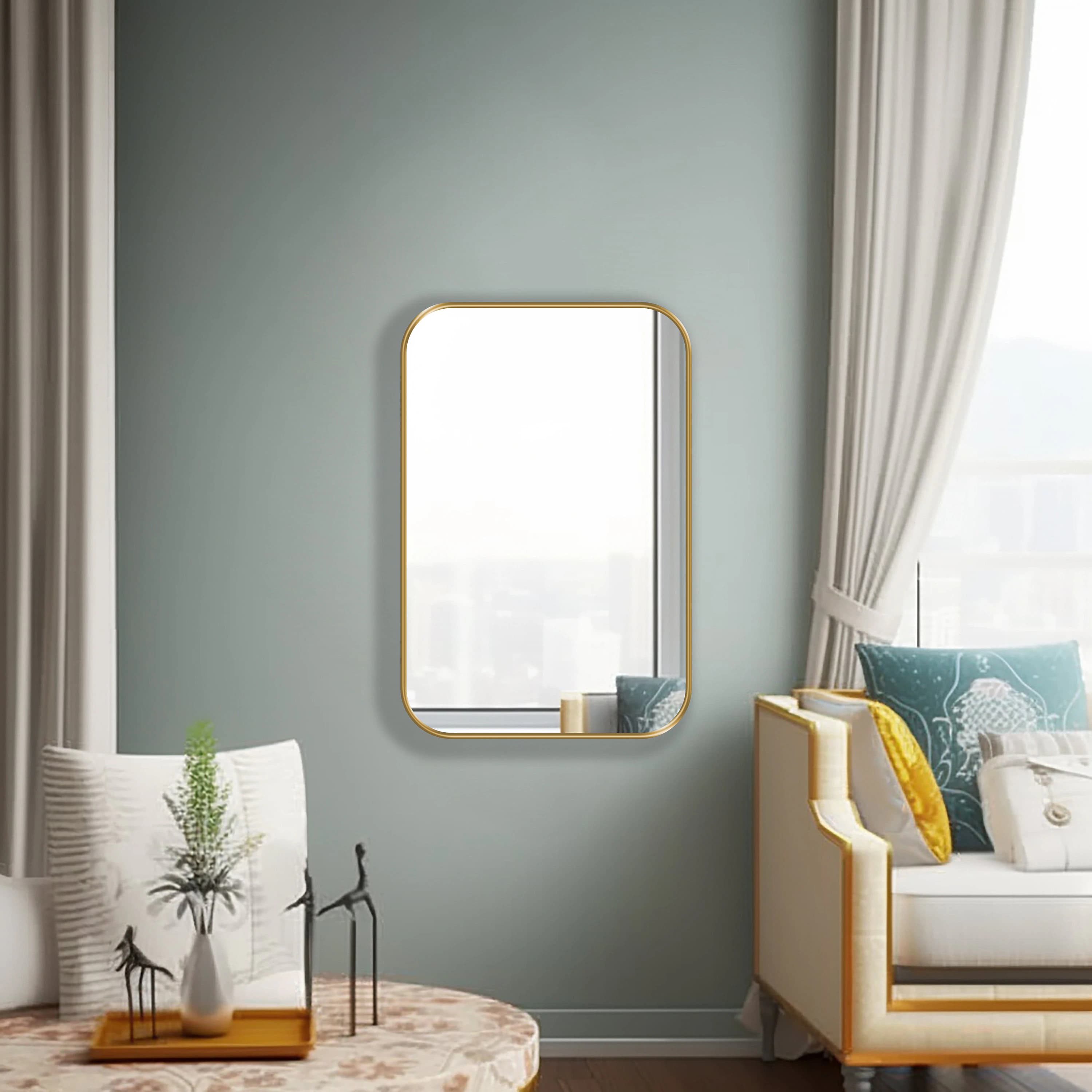 Rectangle mirror with gold frame hung on the wall of a living room.
