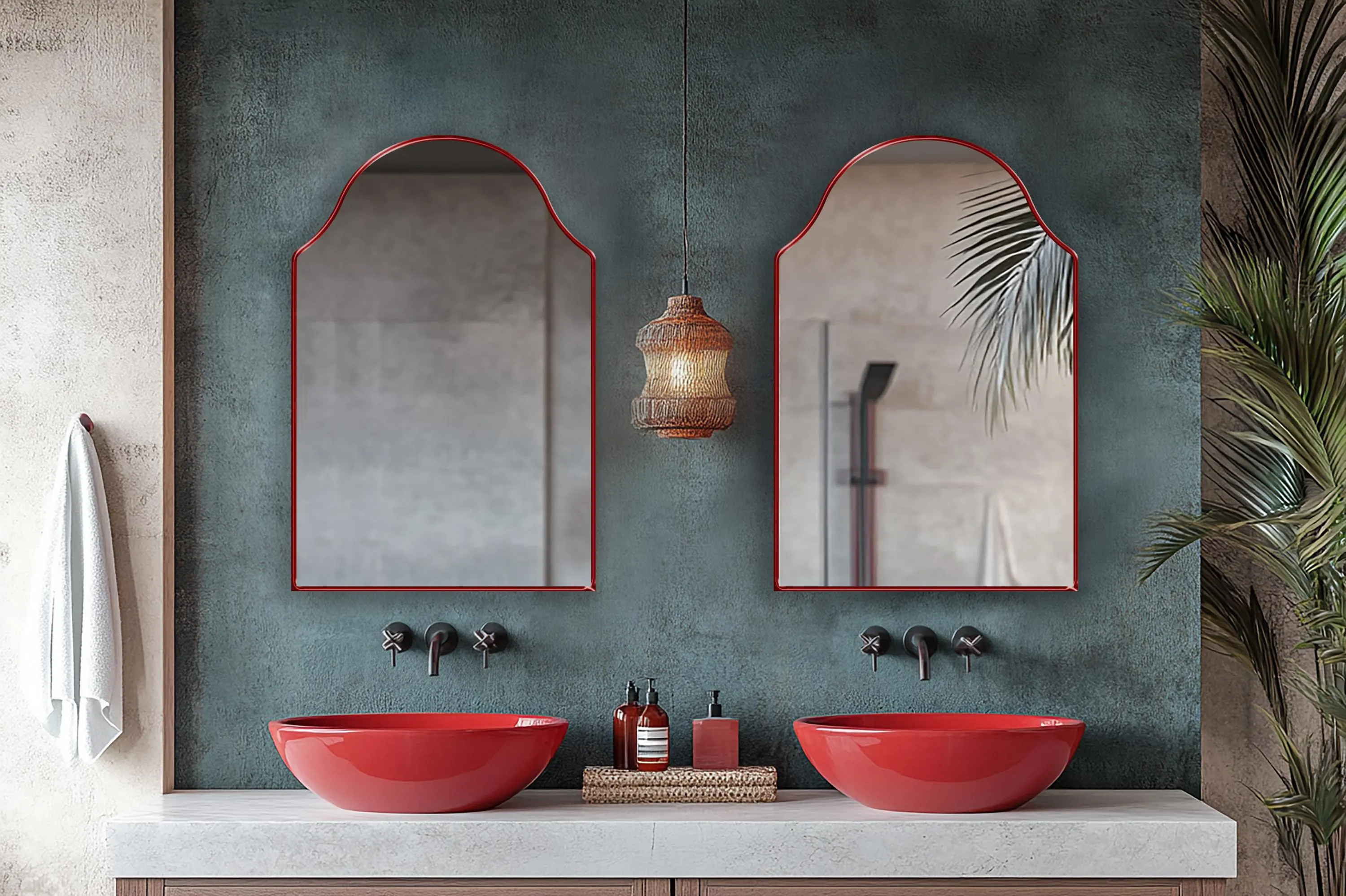 Two Andalusia Mirrors with red frame finish hung on the wall of a powder room over a double vanity.