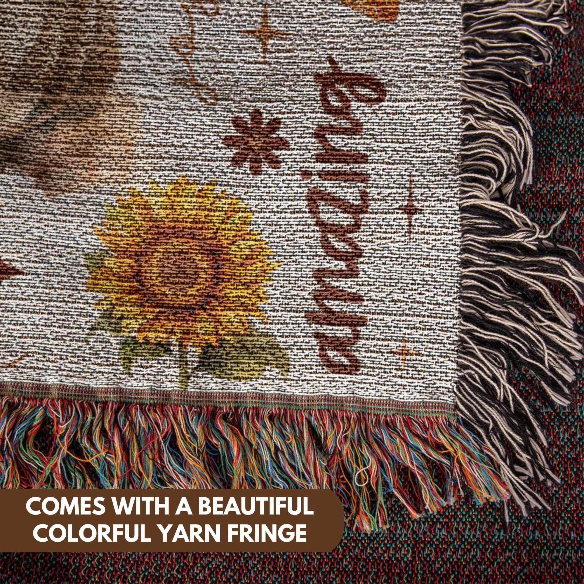 a close up of a blanket with a picture of a flower on it