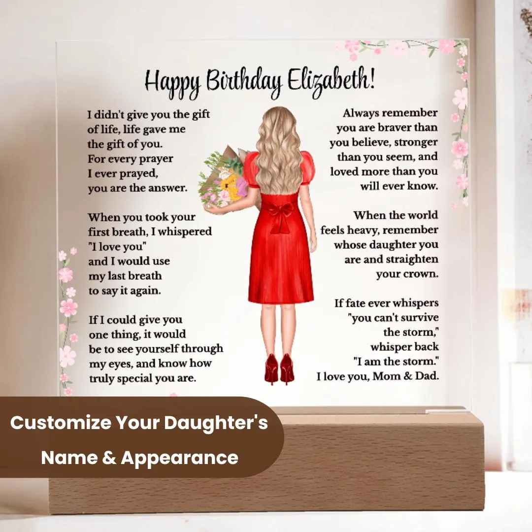 May include: A personalized acrylic plaque displayed on a wooden LED base in a modern home setting. The custom design features a heartfelt birthday message, pink floral accents, and an illustrated girl with blonde hair wearing a red dress and holding a bouquet. There is a dark brown overlay that states: Customize Your Daughter's Name & Appearance. Decorative plants and dried florals are shown in the background.