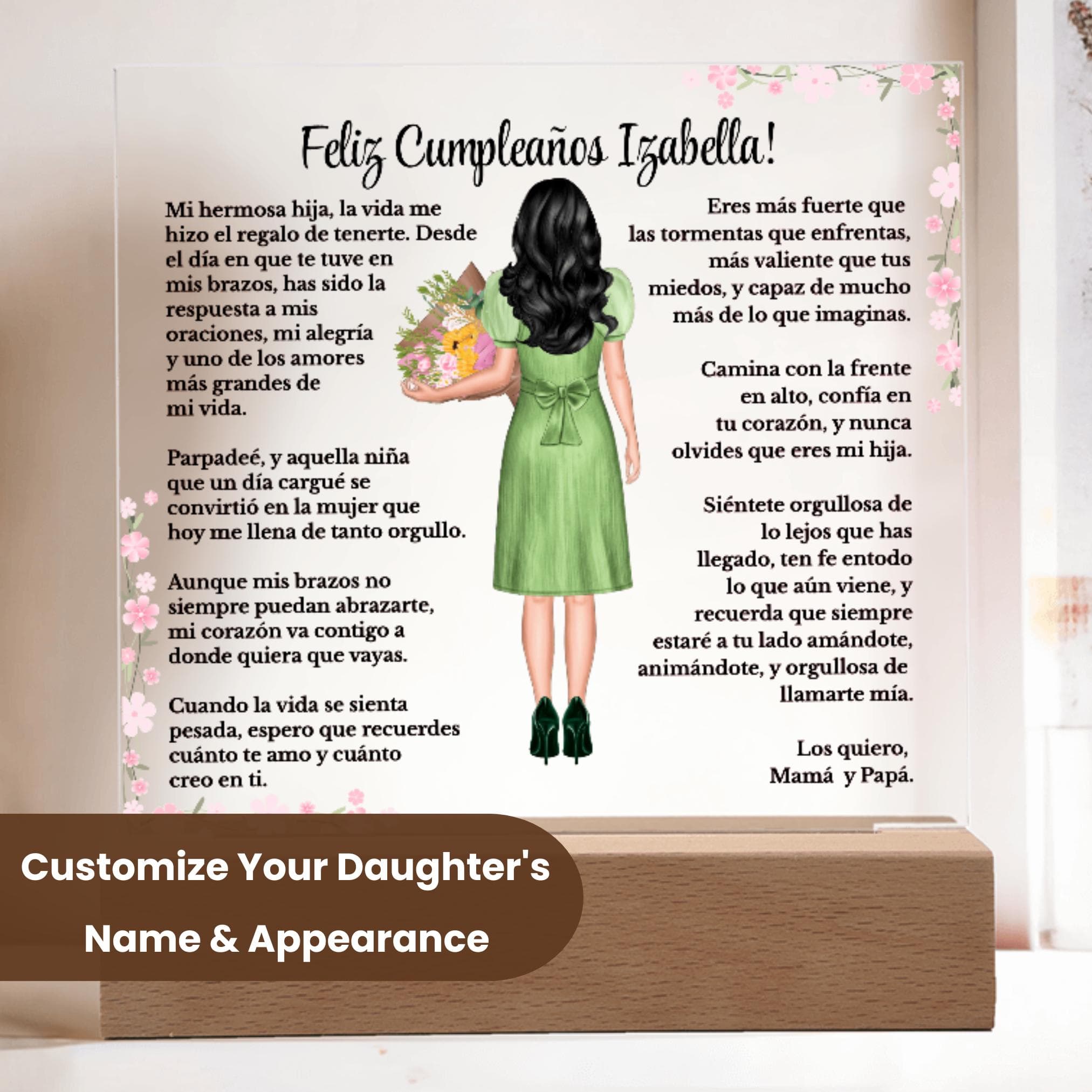 May include: A personalized acrylic plaque displayed on a wooden LED base in a modern home setting. The custom design features a heartfelt birthday message, pink floral accents, and an illustrated girl with long black wavy hair wearing a green dress and holding a bouquet. There is a dark brown overlay that states: Customize Your Daughter's Name & Appearance. Decorative plants and dried florals are shown in the background.