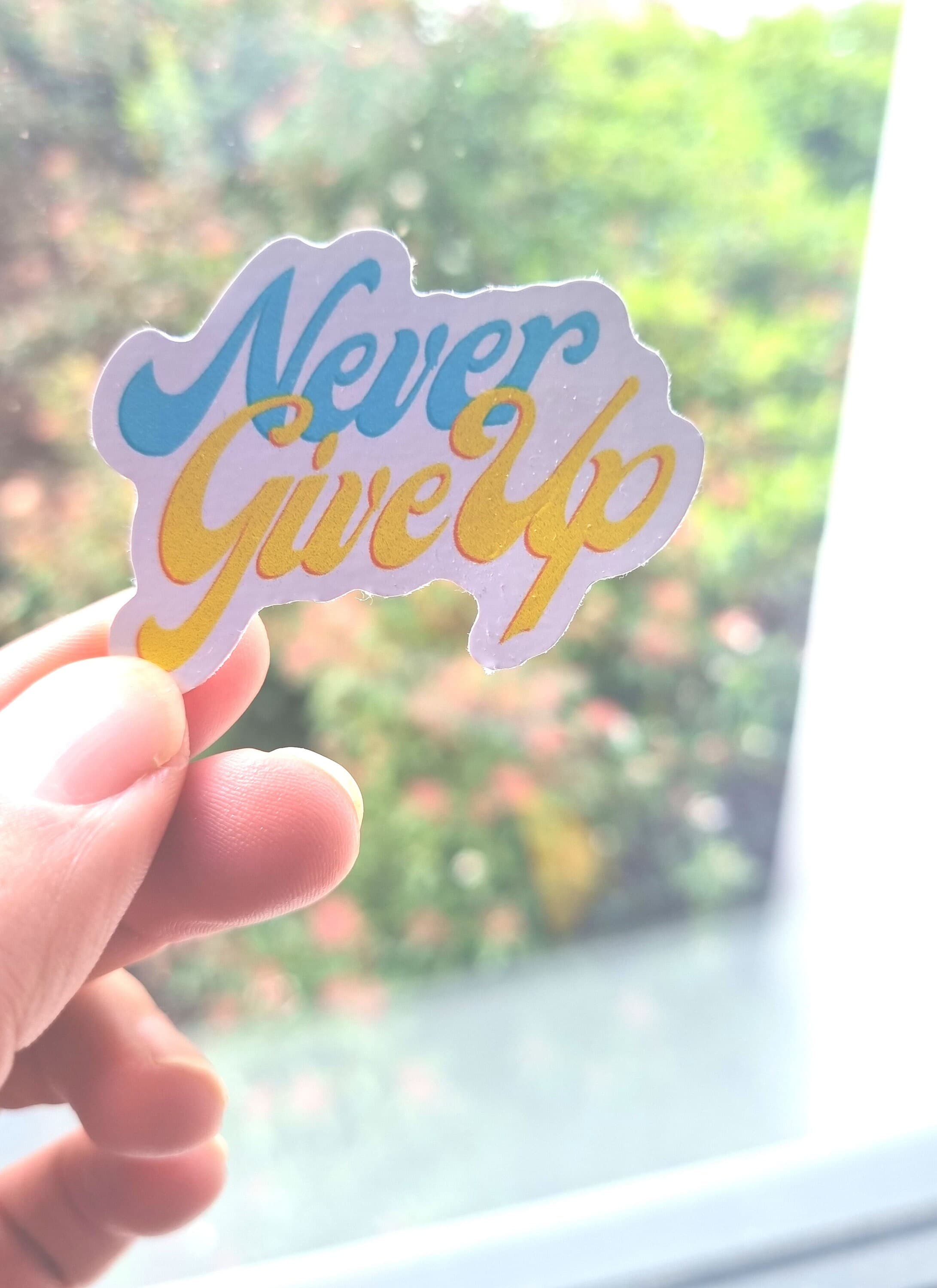 Never give up Sticker with the highest quality inks and vinyl .