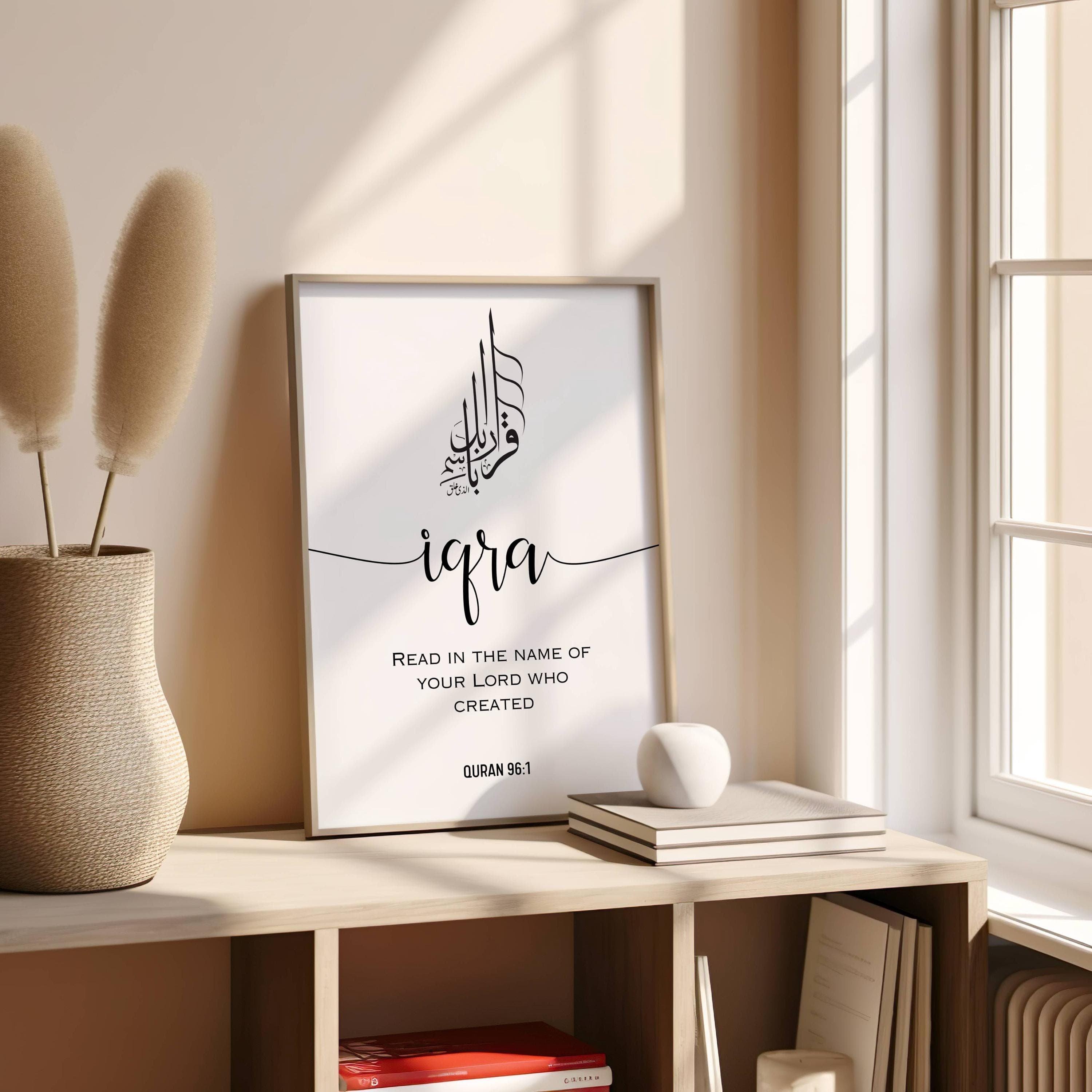 Minimalist Arabic calligraphy featuring the Quranic verse IQRA ;Read in the name of your Lord who created(Quran 96:1) in an elegant black-and-white design. Below it is written the full verse translation in engl;ish in capital easy to read letters this  modern elegant fonts decor adds a modern touch, making it perfect for a study, prayer room, or living space. This Islamic digital download is ideal for Muslim home decor, Quran-inspired art, and unique Islamic gifts, bringing faith into any space.