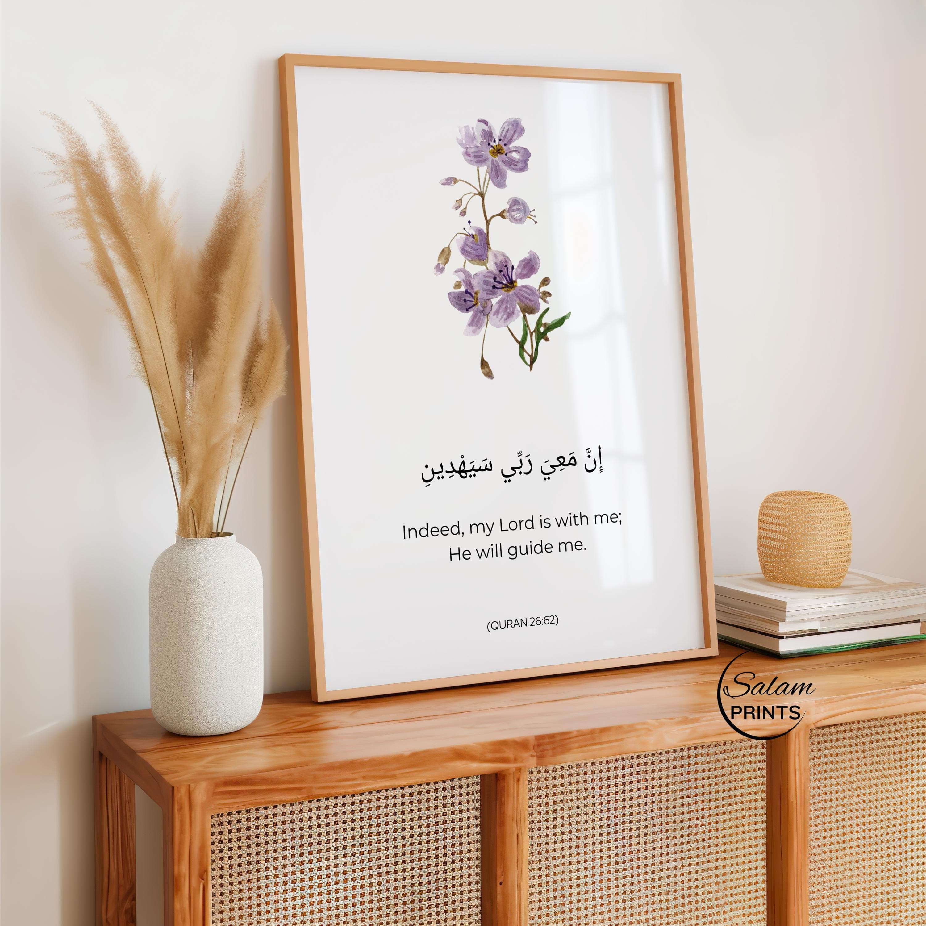 Purple colored flowers on white background with arabic calligraphy of Motivating Quran Verse 8:46 written below the floral design . Indeed My Lord is with me, He will Guide me. and below it is written its english translation .This minimalist Quranic verse print showcases the importance of Reliance on Allah in Islamic Lives. Adorned with Minimalist flower and arabic Calligraphy and english translation, This is a perfect Islamic poster for Muslim Homes.