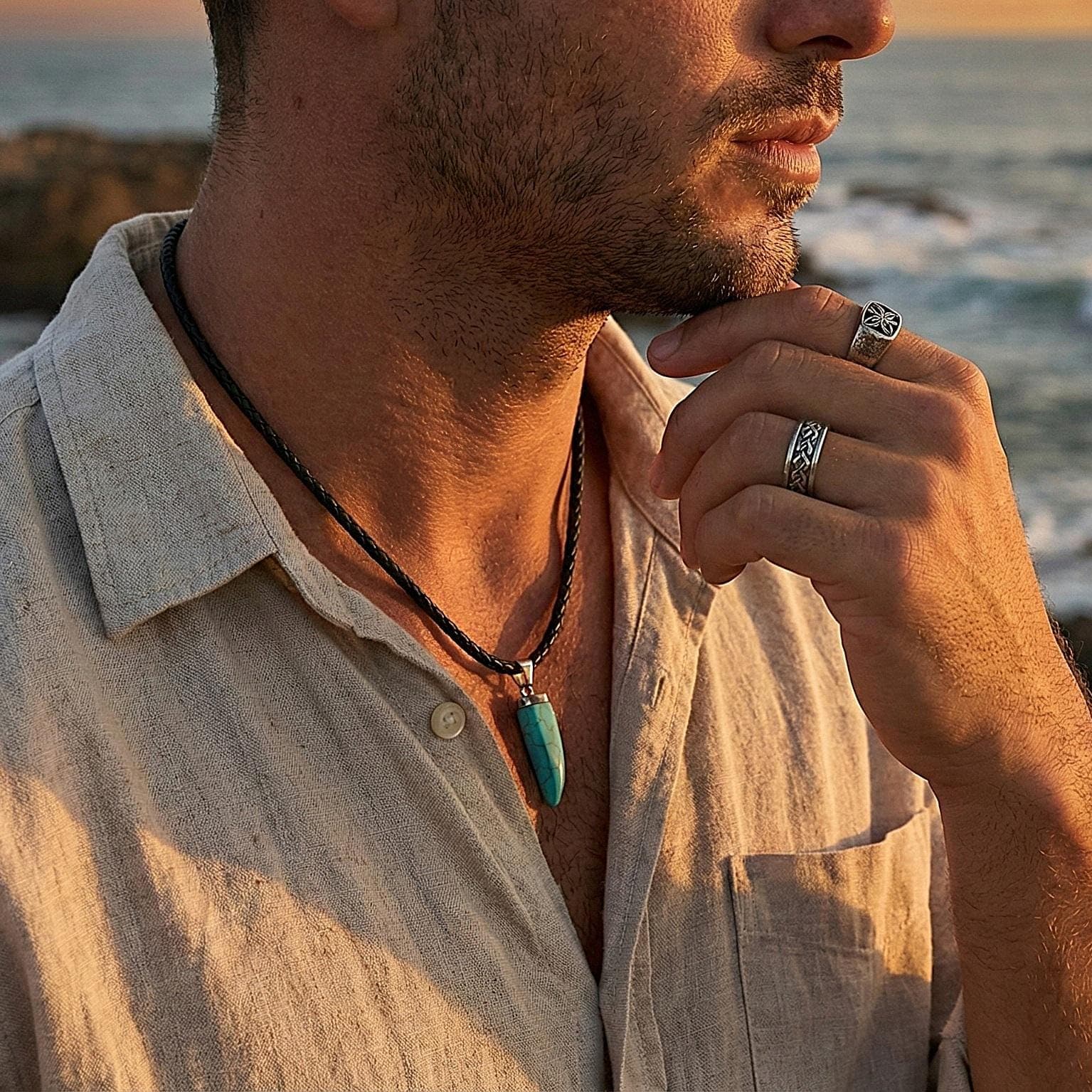 Model wearing a turquoise tusk necklace with a denim shirt, showcasing southwestern western style jewelry and masculine fashion accessories.