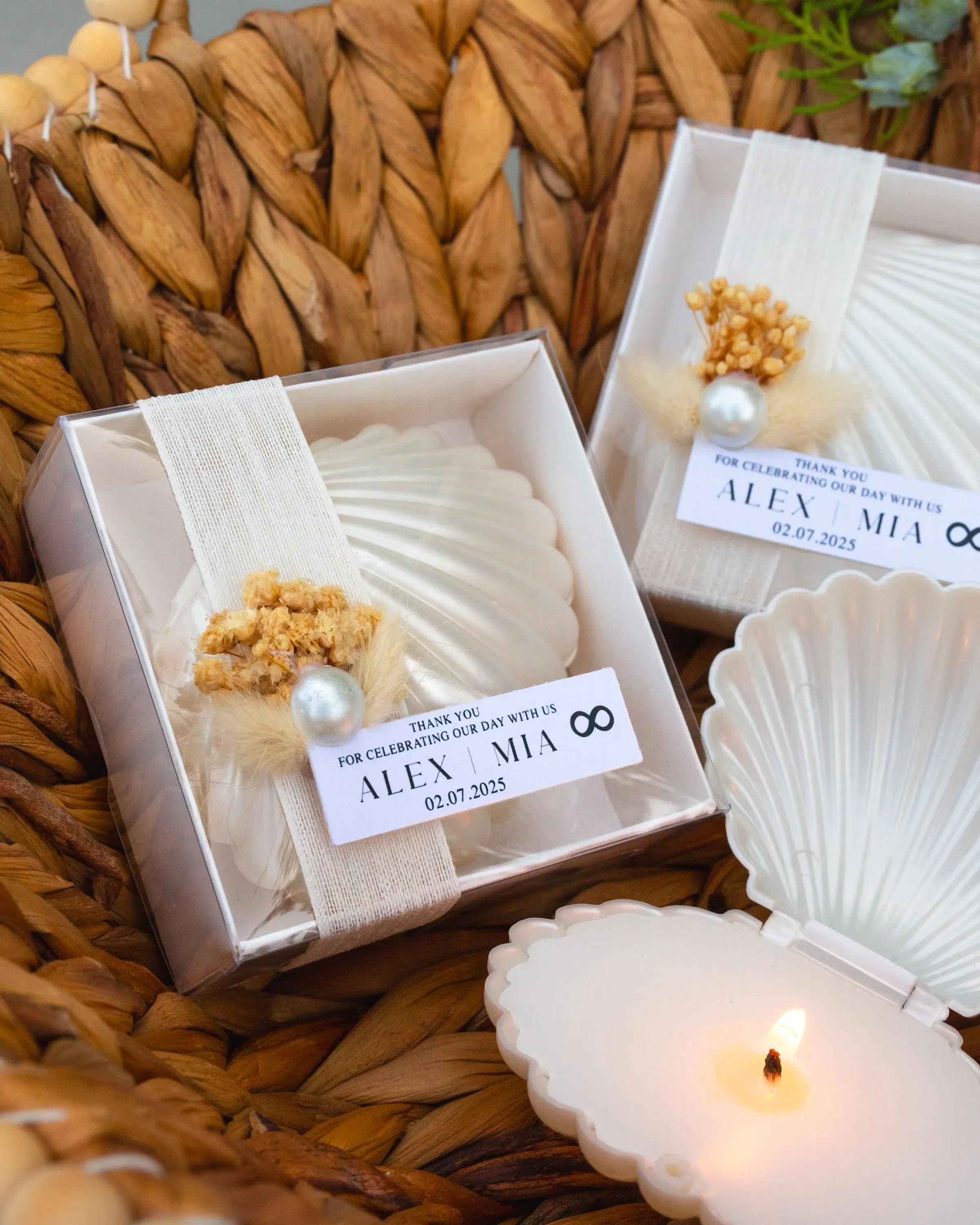 Elegant seashell candle favor with personalized tag, ribbon bow and florals, perfect for bridal shower or coastal party keepsake.