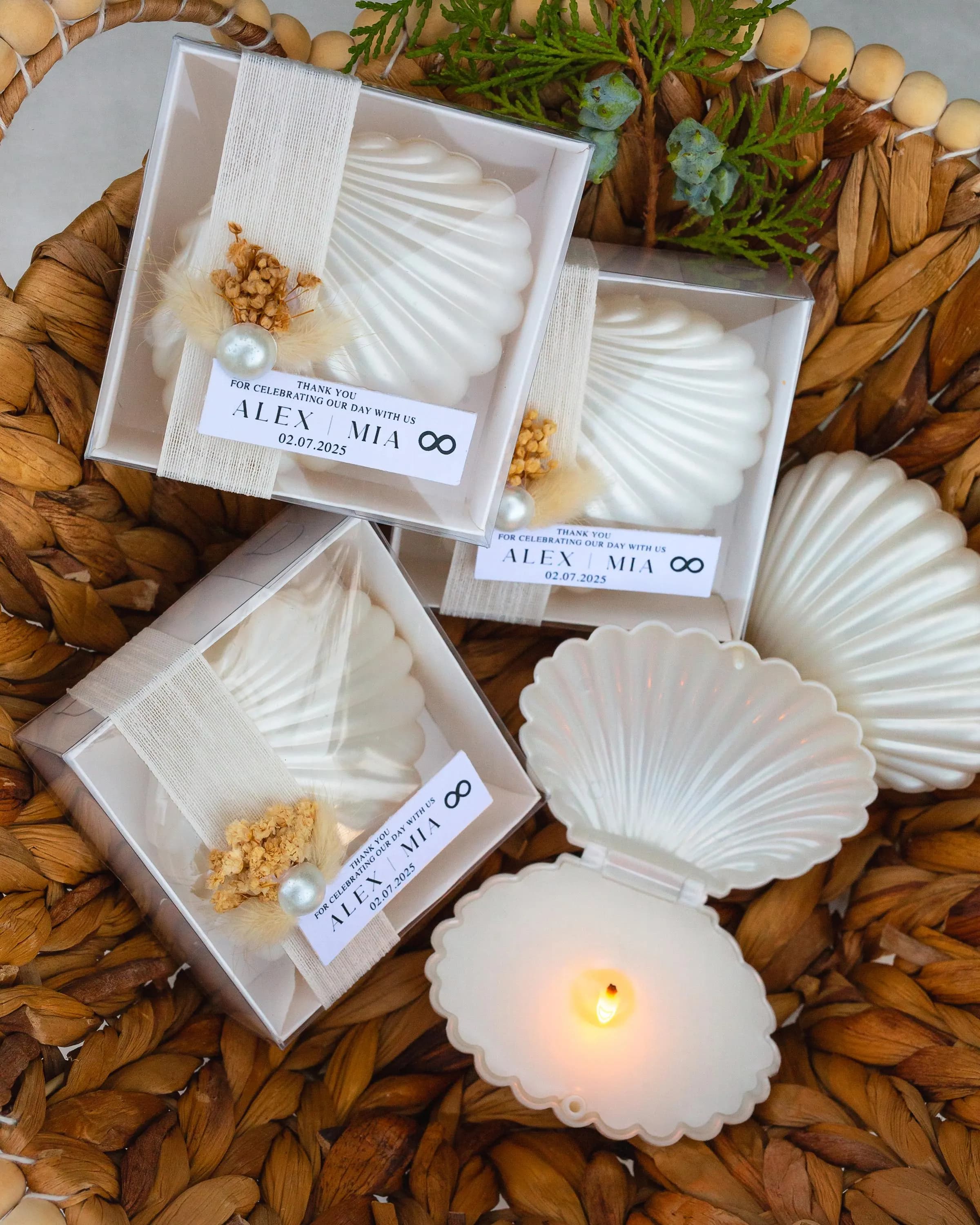 Beach wedding seashell candle favor, handmade with soy wax and adorned with ribbon and dried flowers in clear gift box.