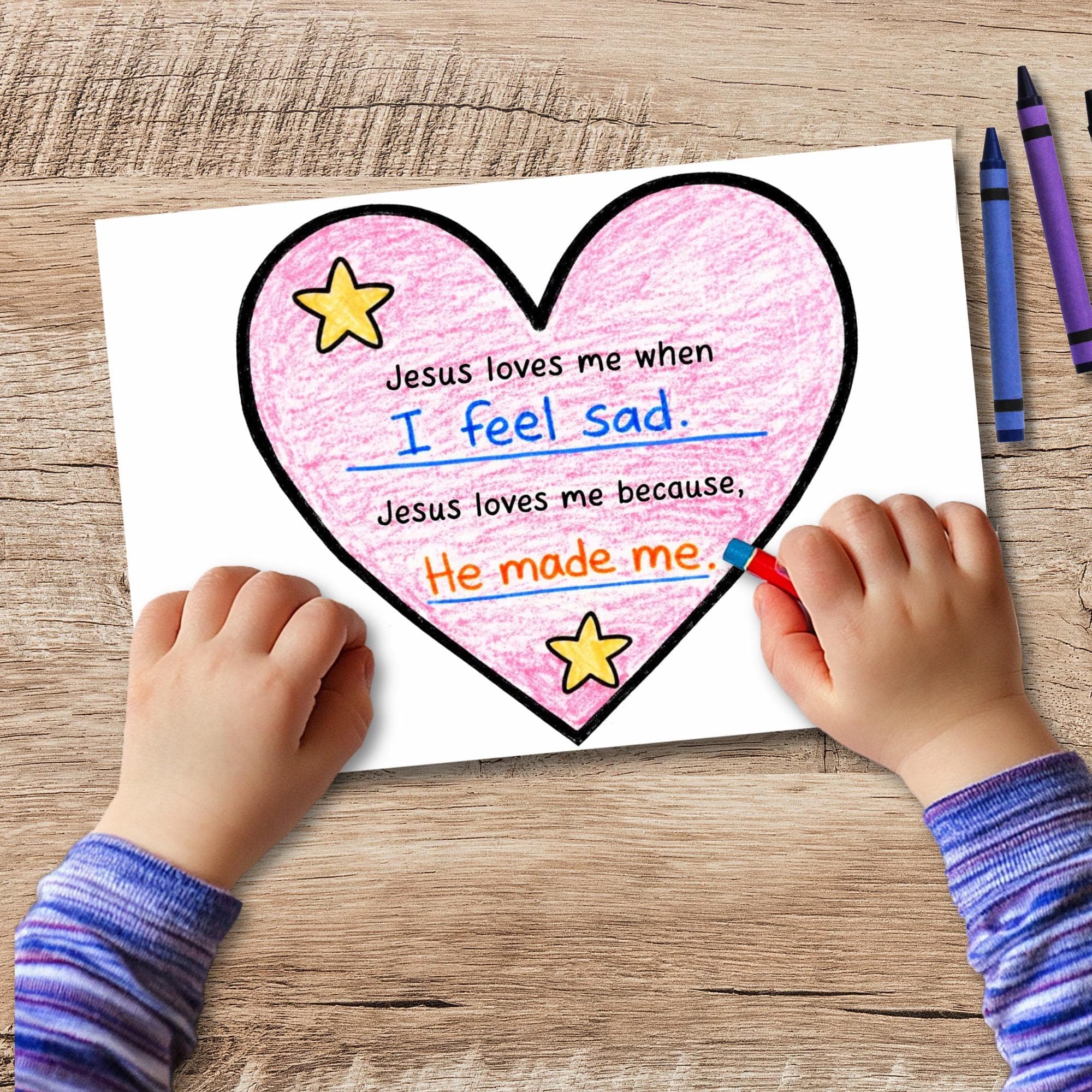 Finished heart craft activity for kids featuring “Jesus loves me” writing prompt, faith based coloring and scripture lesson printable.