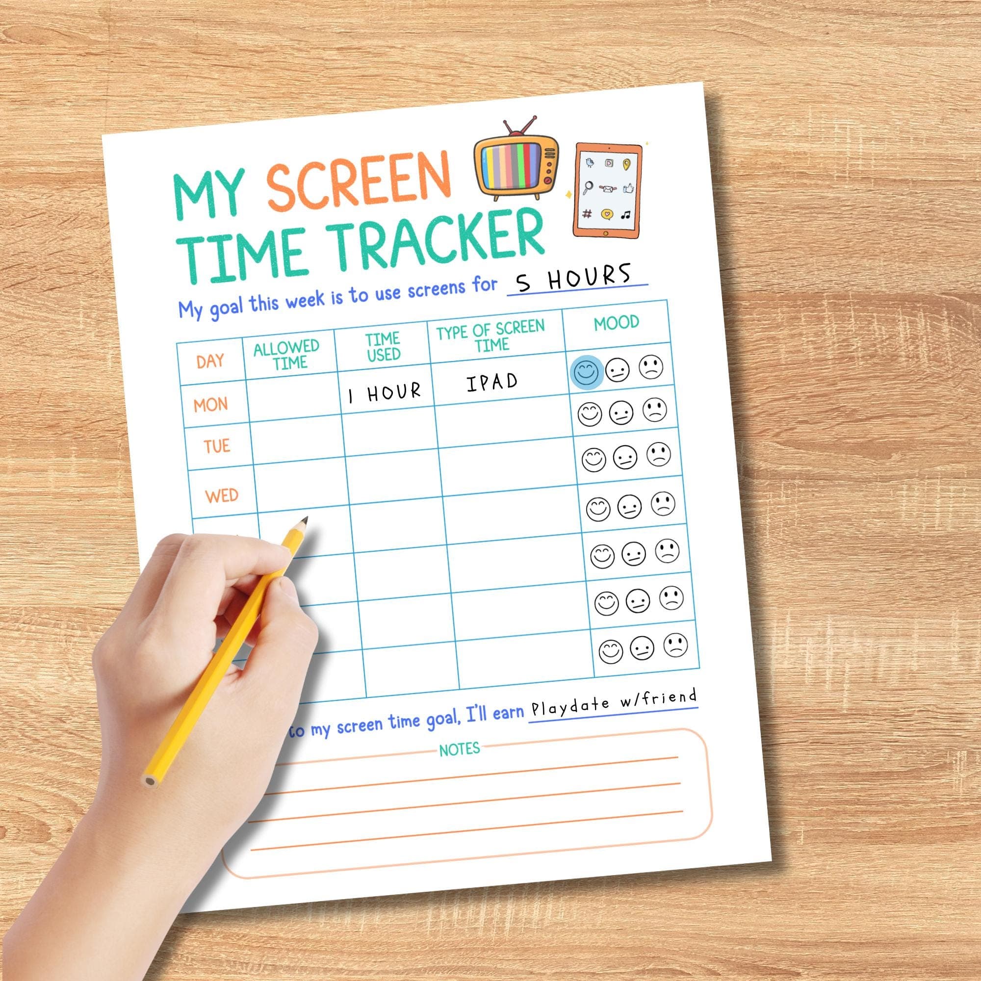 Childs hand filling in the screen time tracker worksheet