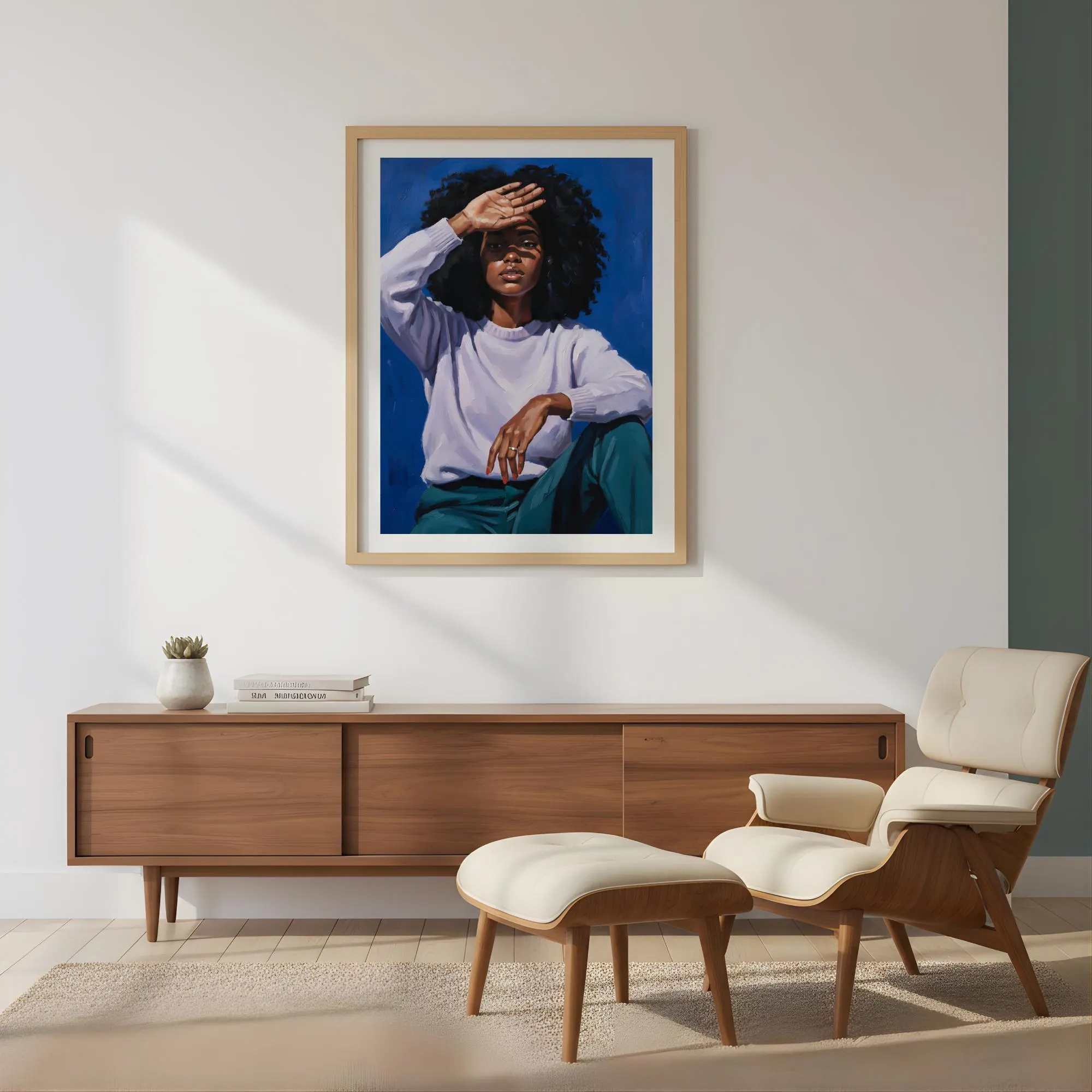 Modern Black woman portrait with natural afro, hand shielding eyes, warm contemporary lighting, shown in white frame on neutral wall