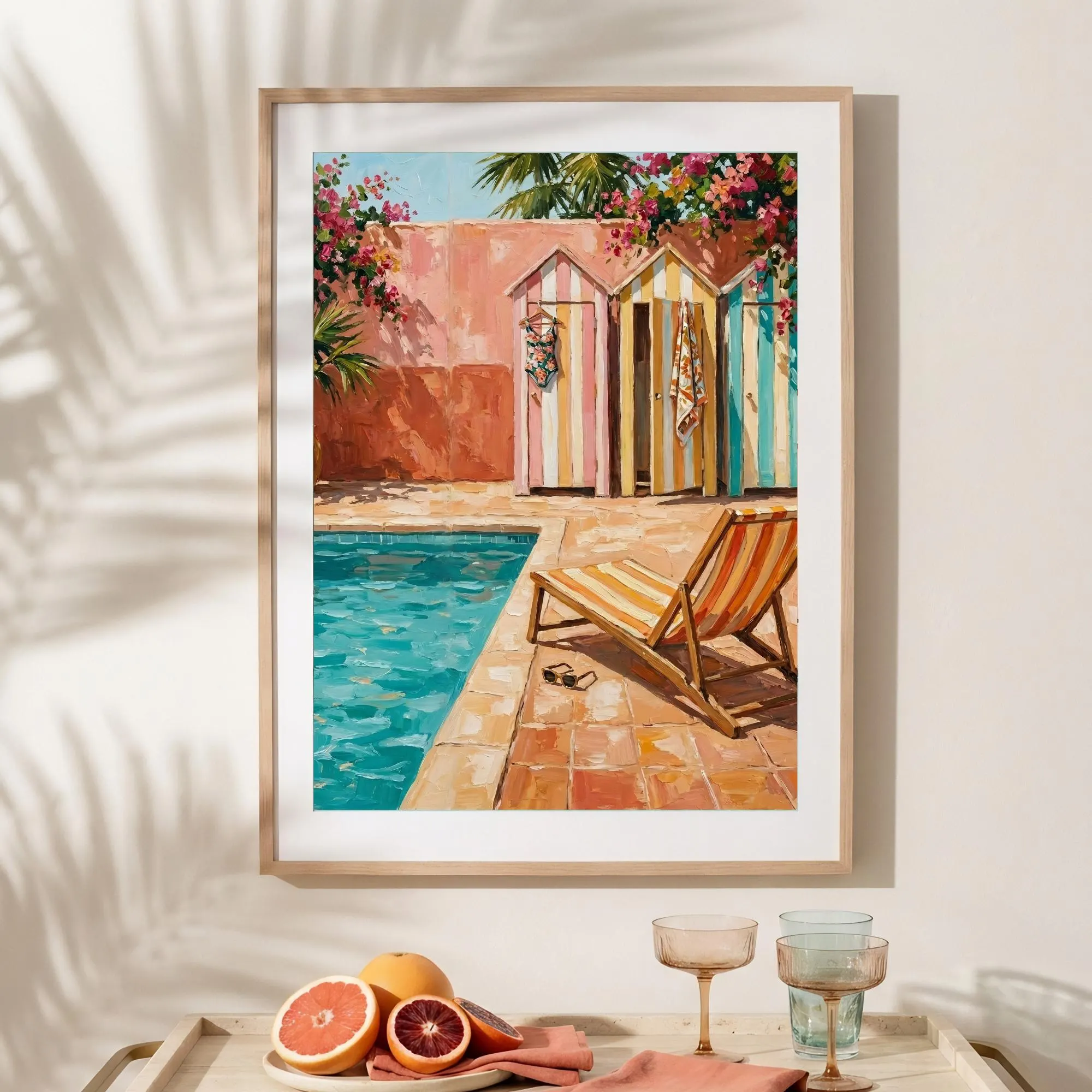 Sunlit coastal wall art mockup with framed poolside cabanas painting and citrus styling in a bright vacation-inspired interior