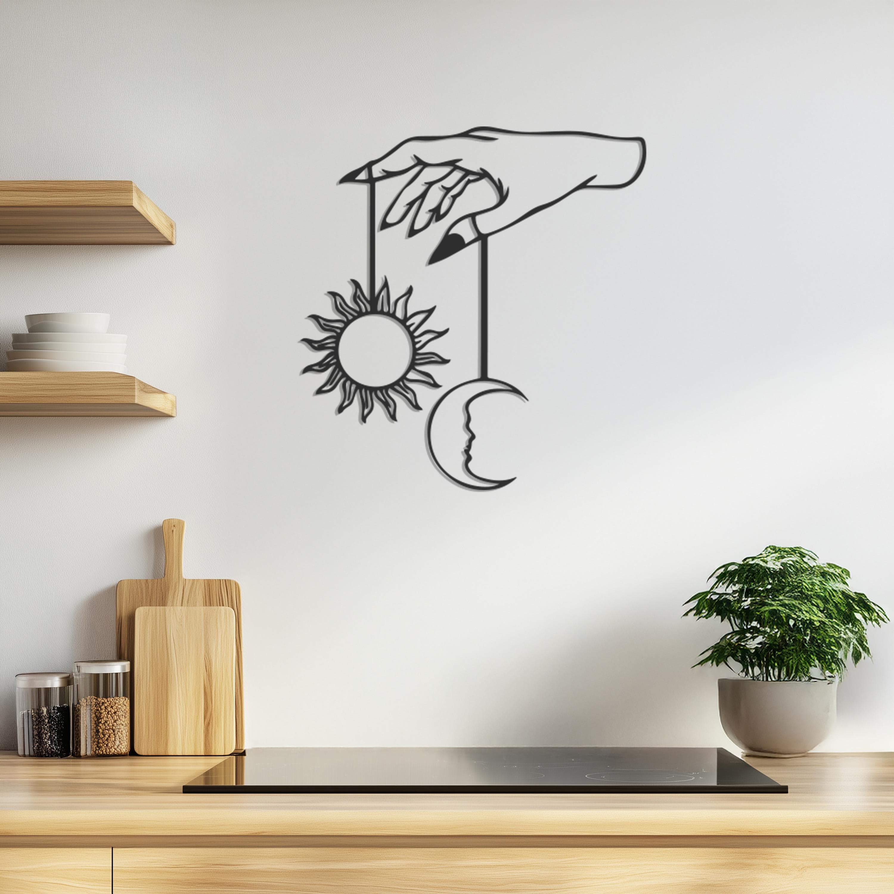 Black line art of a hand holding a sun and crescent moon.