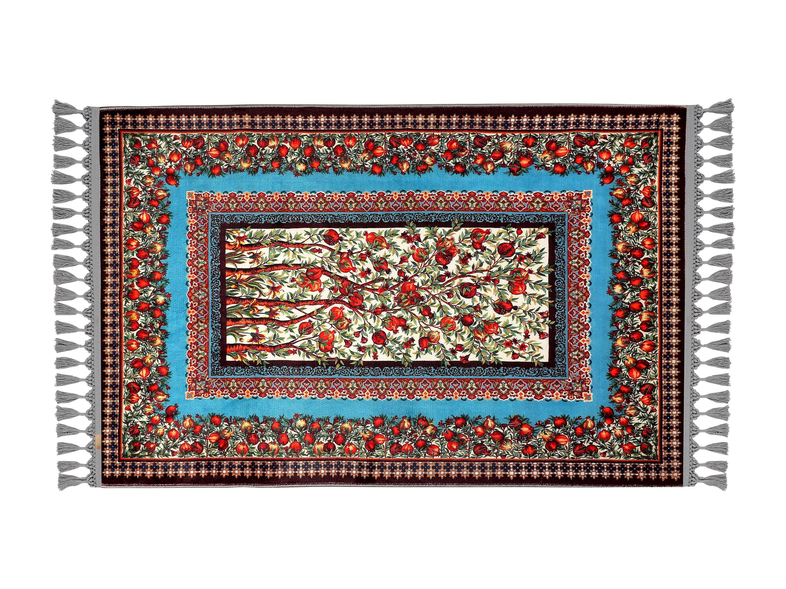 Turkish prayer rug with a blue and red pomegranate motif design, made of soft cotton woven base with non-slip backing. Measures 80x125 cm (31.5"x49.2"), 7 mm thick, and weighs 1.738 kg. Inspired by Islamic symbolism of abundance and blessing, it showcases elegant style with hand-knotted fringes. Ideal for daily prayers at home, travel, or mosque. A meaningful gift for weddings, Ramadan, Eid, or Hajj. Optional name personalization and custom sizing available.