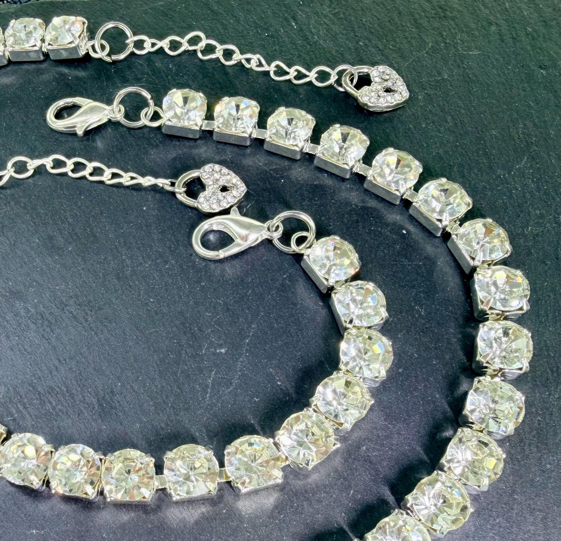 Close-up of faceted stones in silver-toned prongs
