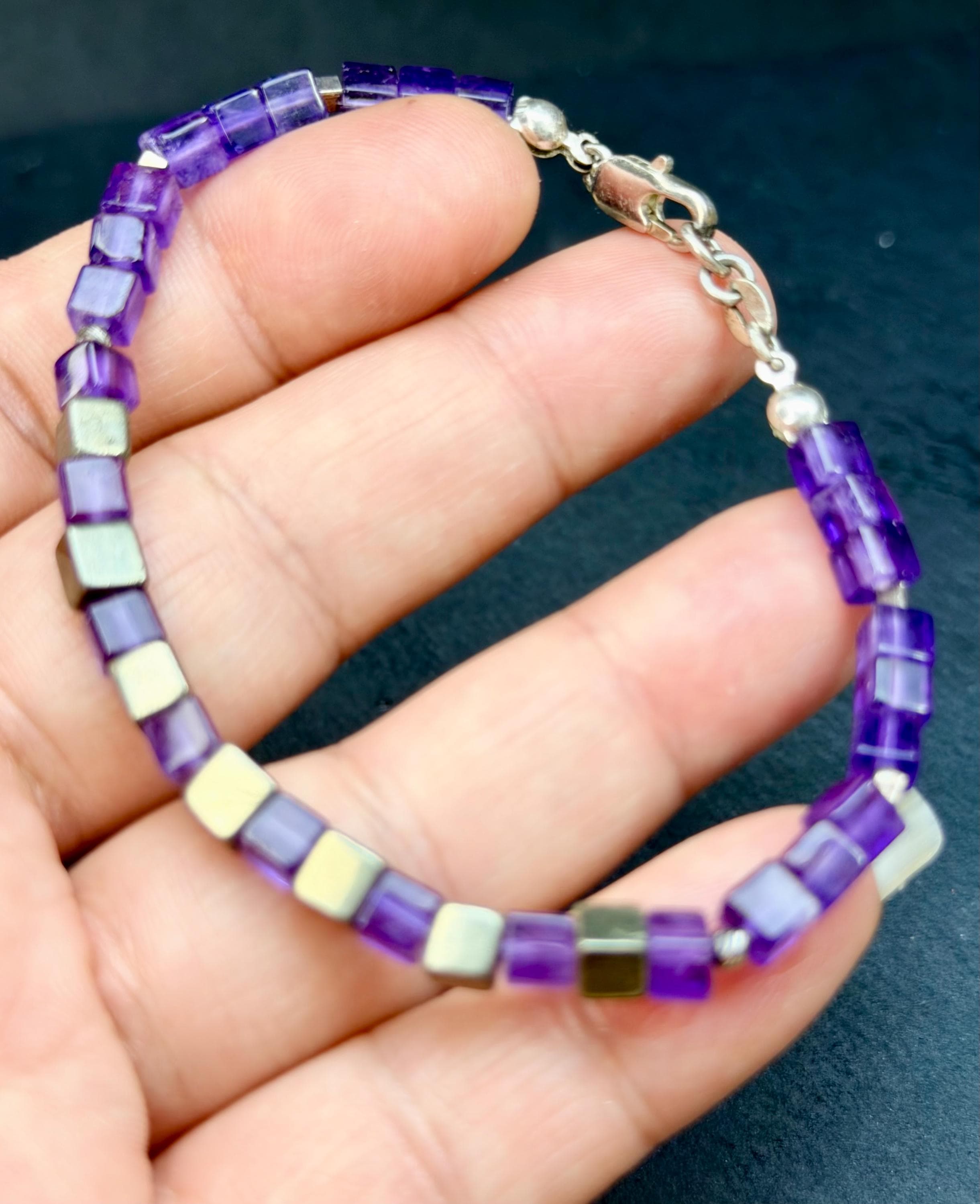 Amethyst and Pyrite Beaded Bracelet, Crown Chakra Energy Healing energy. in a hand