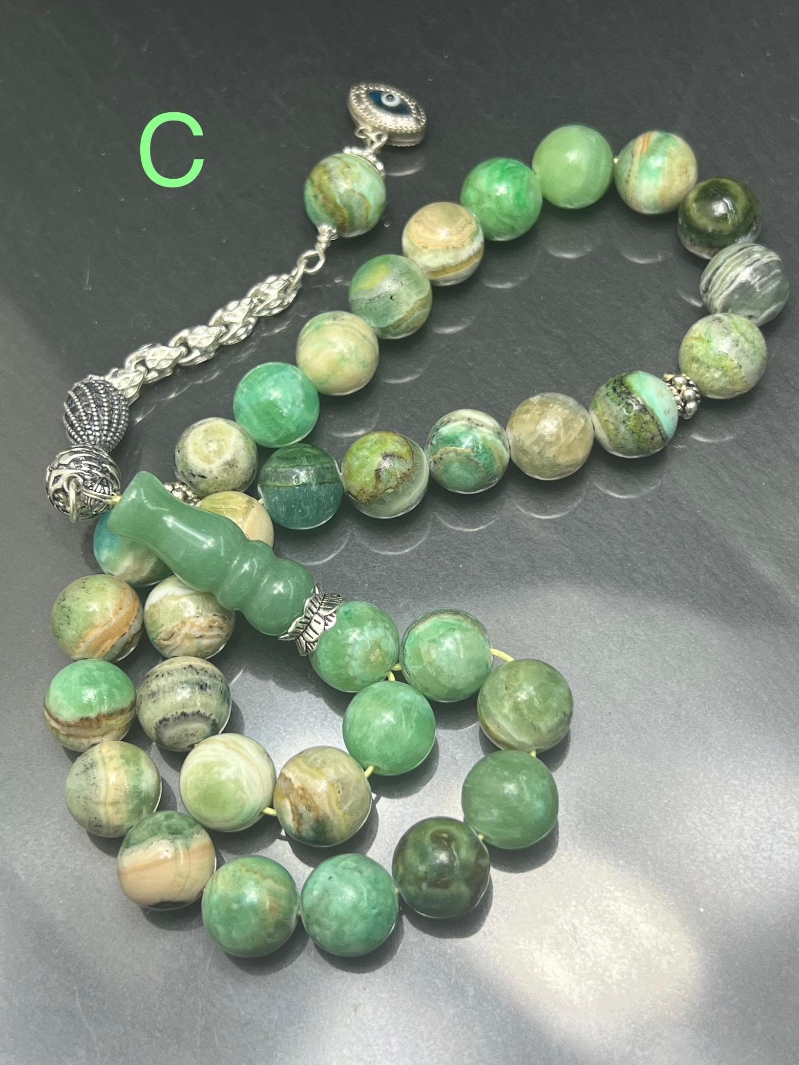 Natural Phoenix Jade Tasbih with 33 beads, handmade with 925 sterling silver tassel. Ideal for Ramadan, Eid al-Adha, AkueShop, spiritual healing, heart chakra energy.