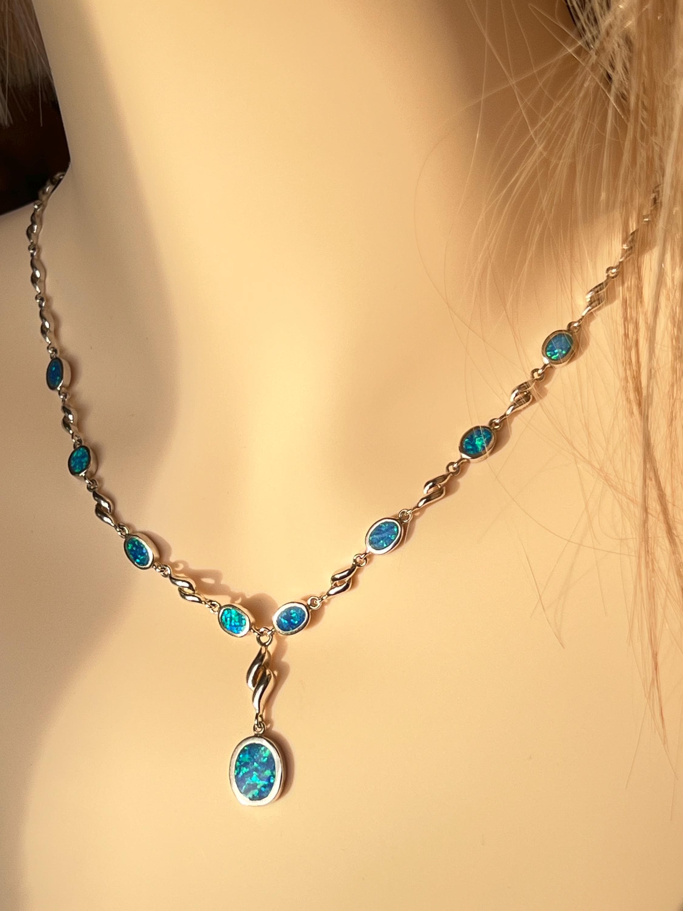Vintage 1980s Y‑necklace in 925 sterling silver with synthetic blue opal stones,  featuring oval bezel‑set opals and twisted silver links with a central drop pendant.