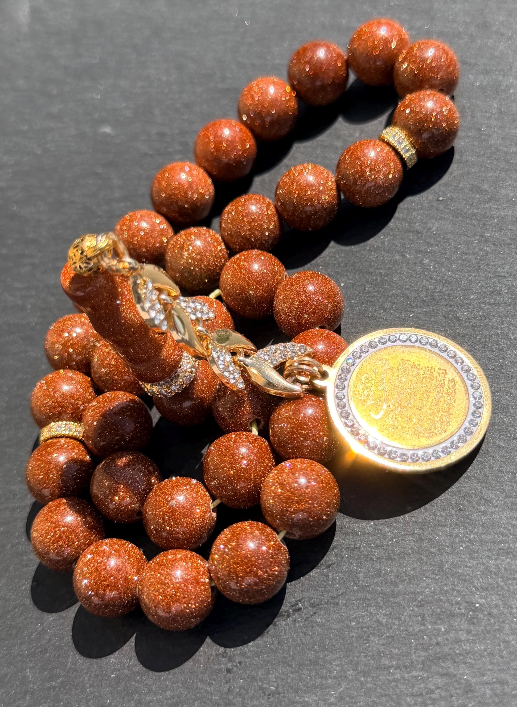 Gold Sandstone Tasbih, gold plated medal in the tassel with Yasin Quran Verses.